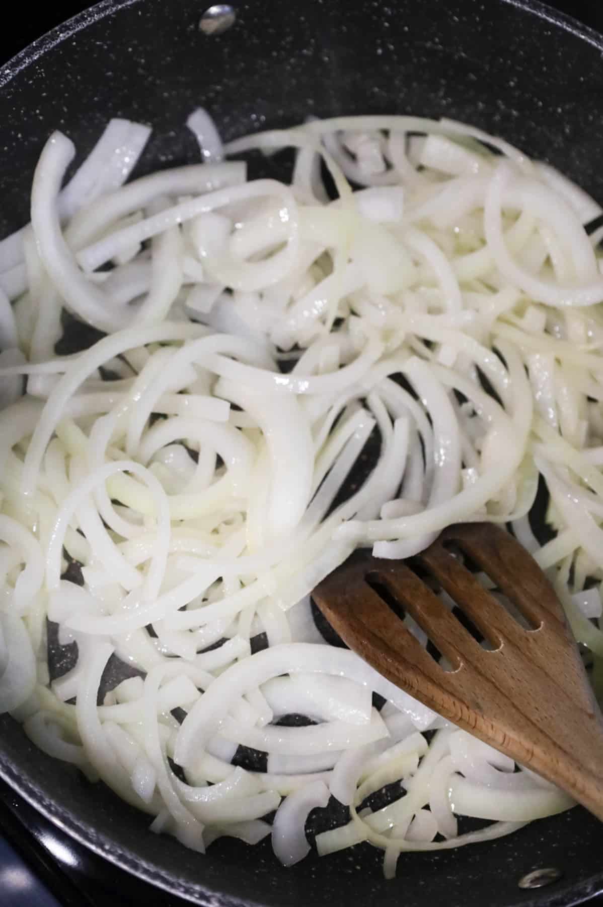 sliced onions cooking in butter in a skillet