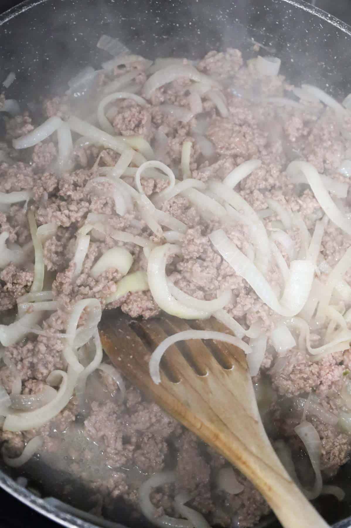 ground beef and onions cooking in a skillet