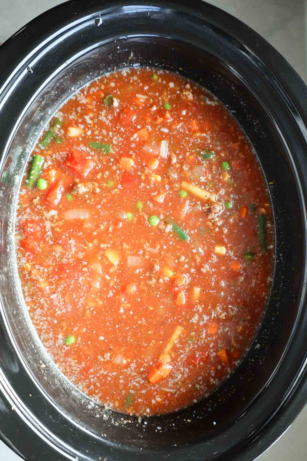 hamburger soup ingredients in a crock pot before cooking