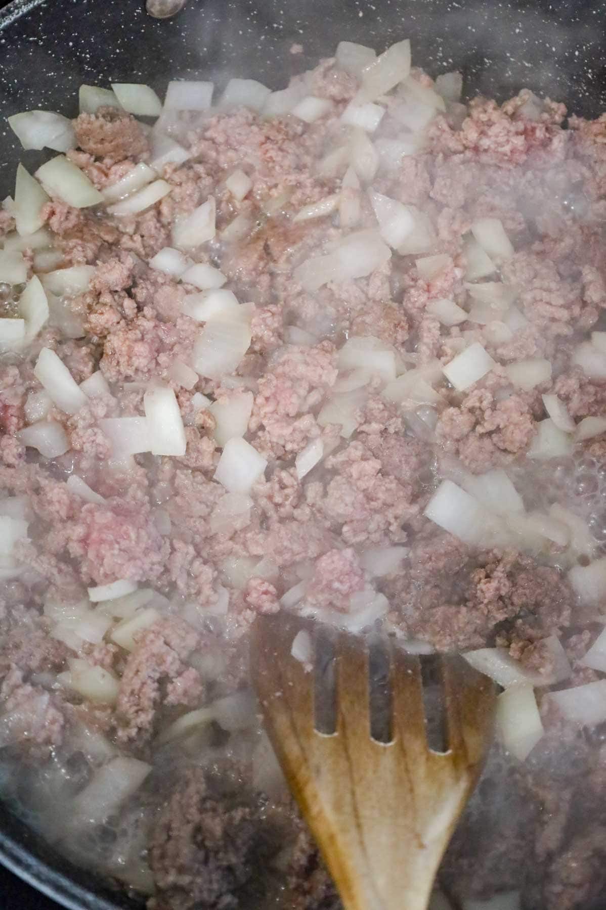 ground beef and onions cooking in a skillet