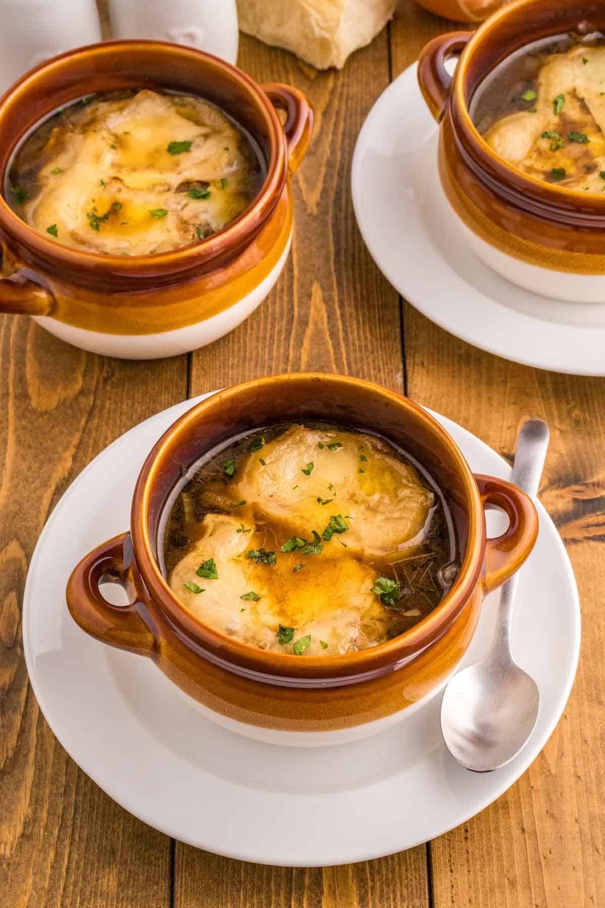 Easy French Onion Soup is a delicious soup with a beef broth base loaded with caramelized onions and topped with baked slices of French baguette and melted Gruyere or Swiss cheese.
