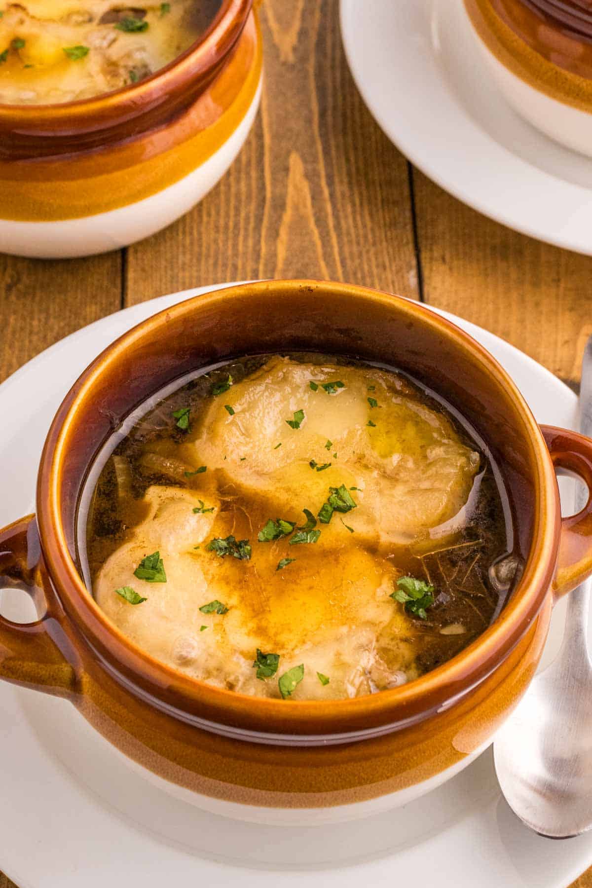 Easy French Onion Soup is a delicious soup with a beef broth base loaded with caramelized onions and topped with baked slices of French baguette and melted Gruyere or Swiss cheese.