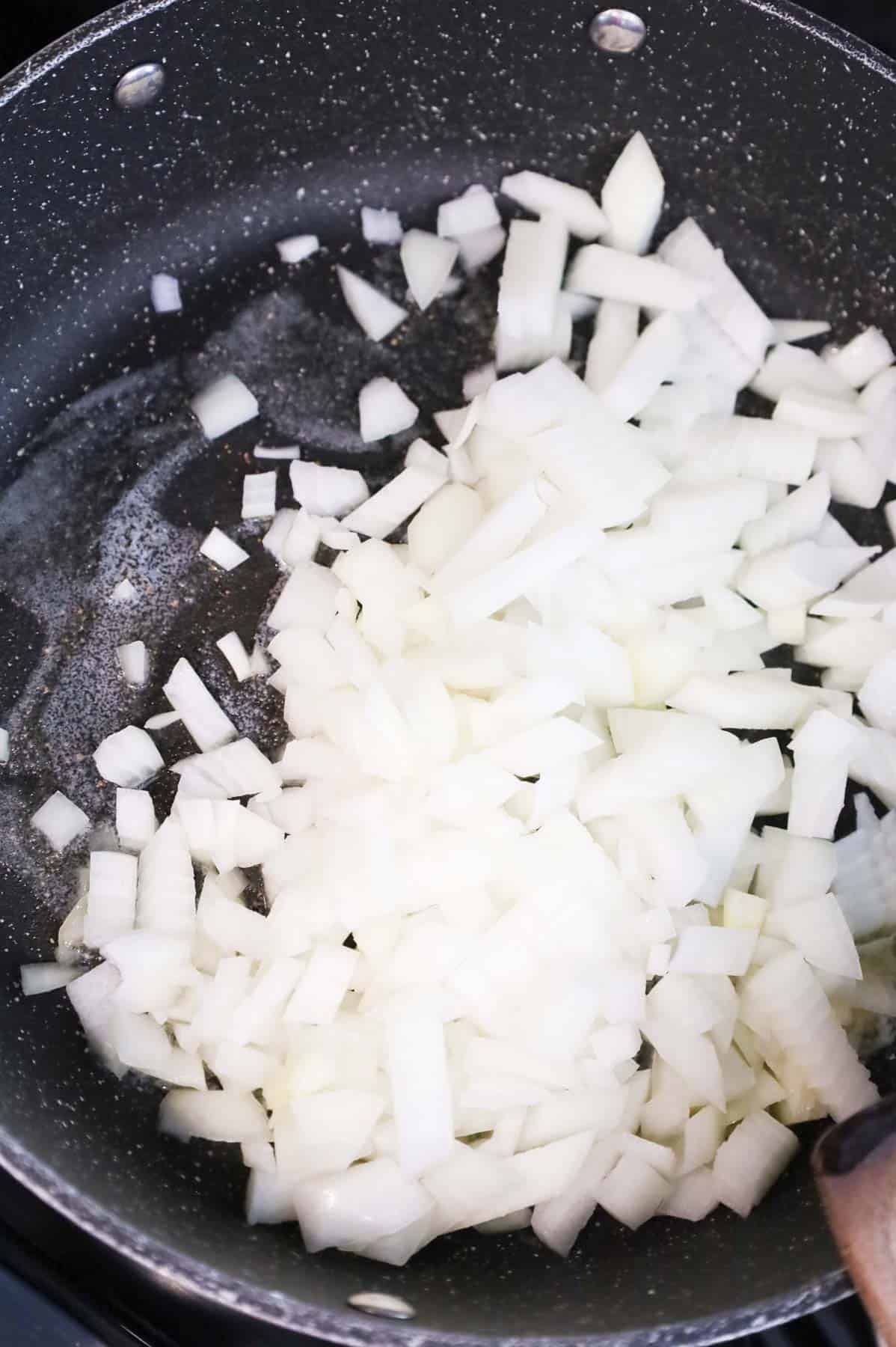 melted butter and diced onions in a skillet