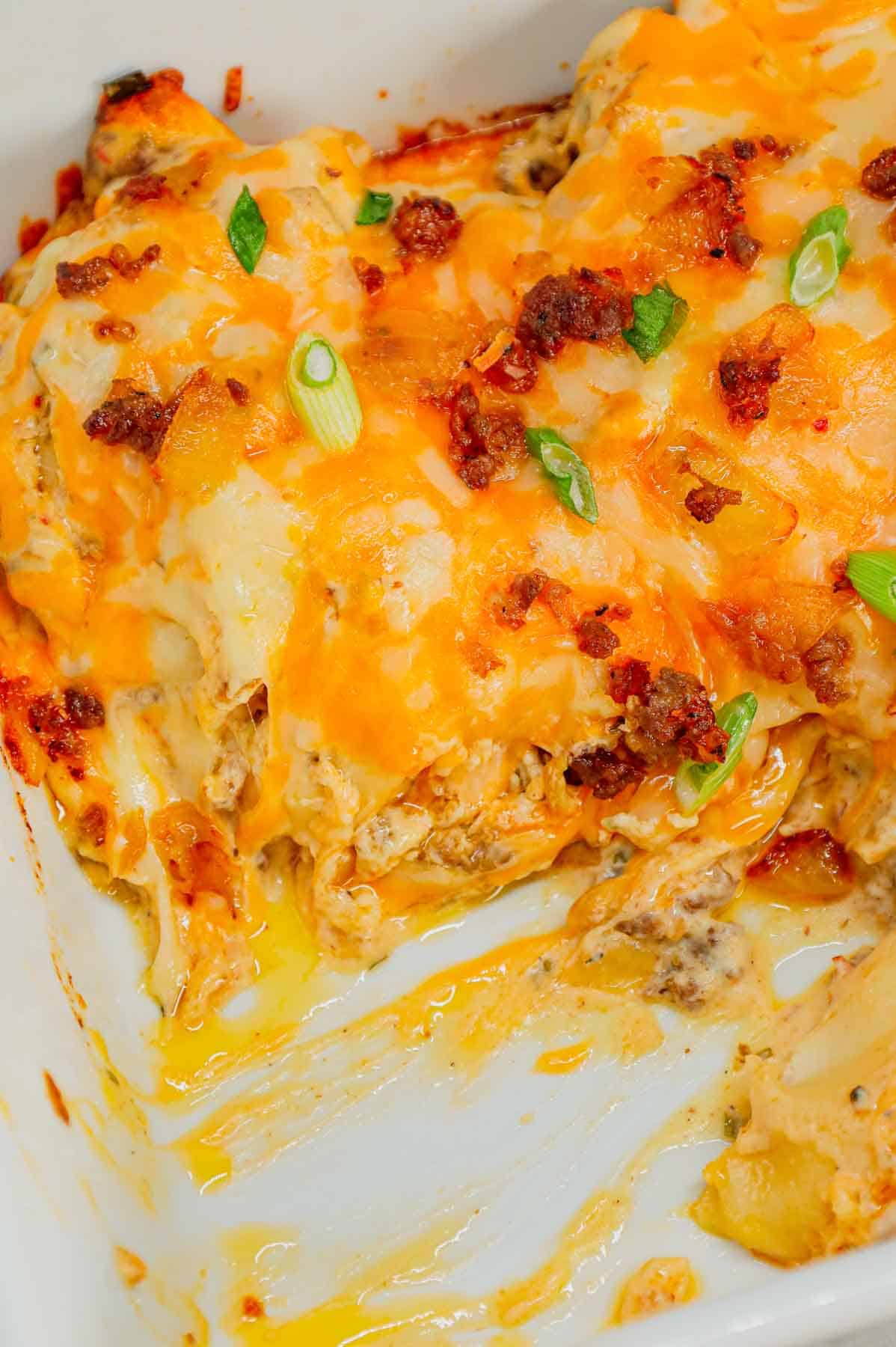 Pierogi Casserole is a hearty dinner recipe loaded with crumbled Italian sausage, onions, three cheese pierogies, cream cheese, Alfredo sauce, shredded mozzarella and cheddar cheese.