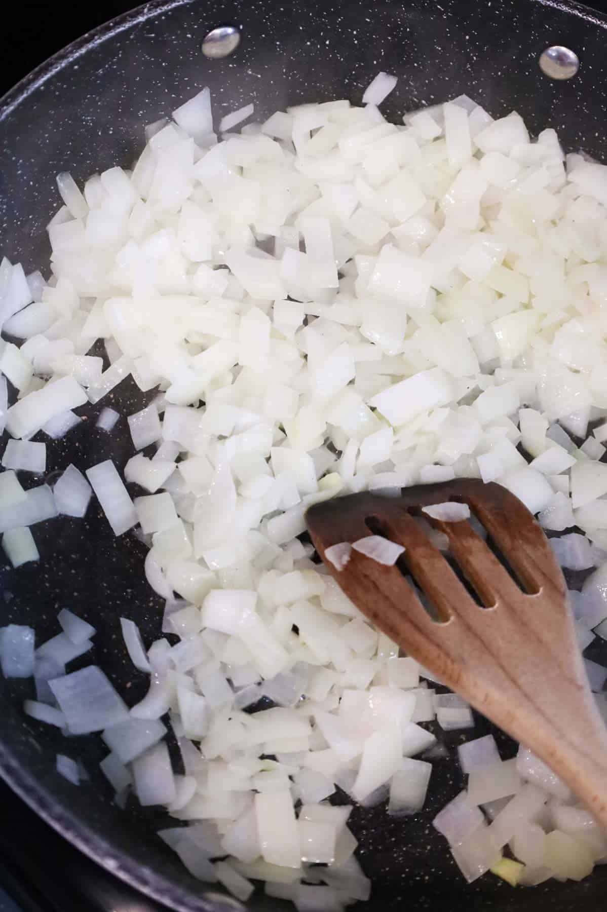 diced onions cooking in a skillet