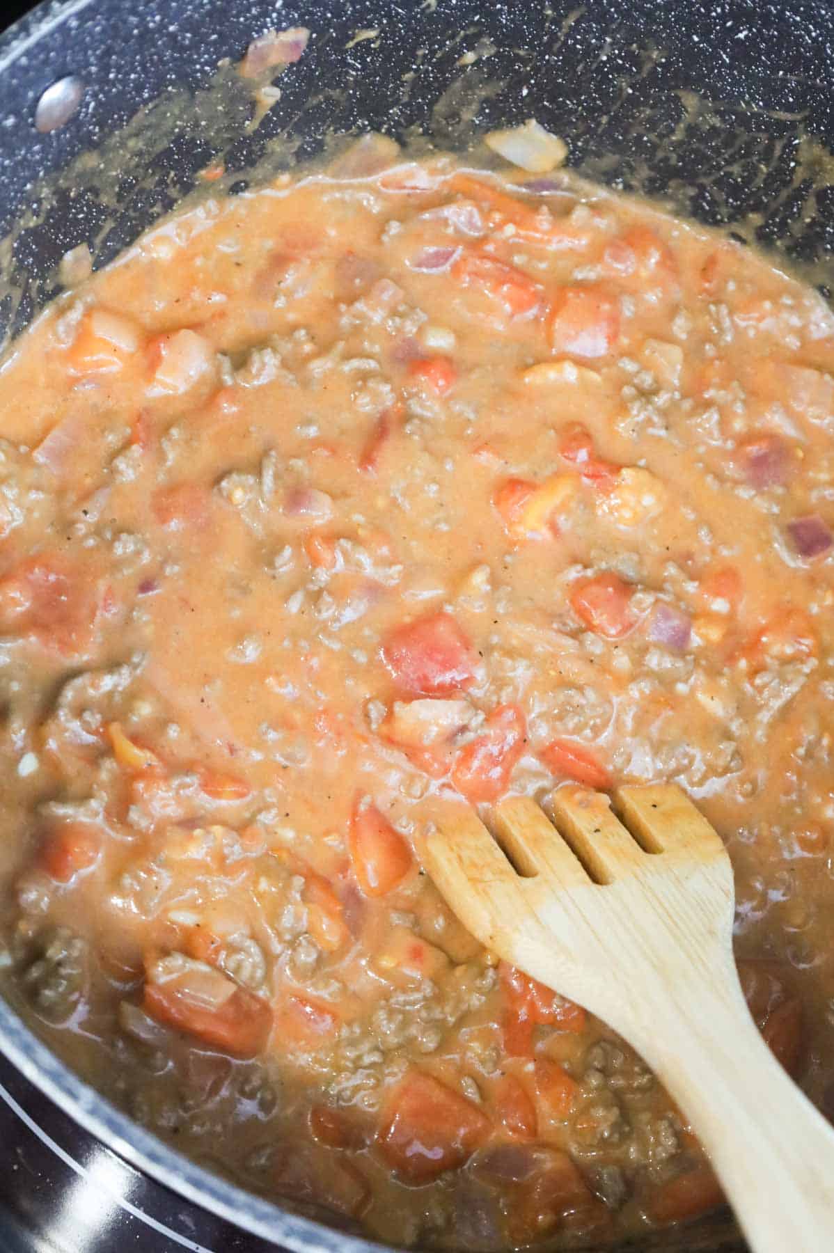 stirring ketchup, mustard, salt and pepper into ground beef mixture