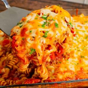 Cheeseburger Casserole is a hearty dish loaded with rotini pasta, ground beef, diced red onions, diced tomatoes, cheddar soup and shredded cheddar cheese.