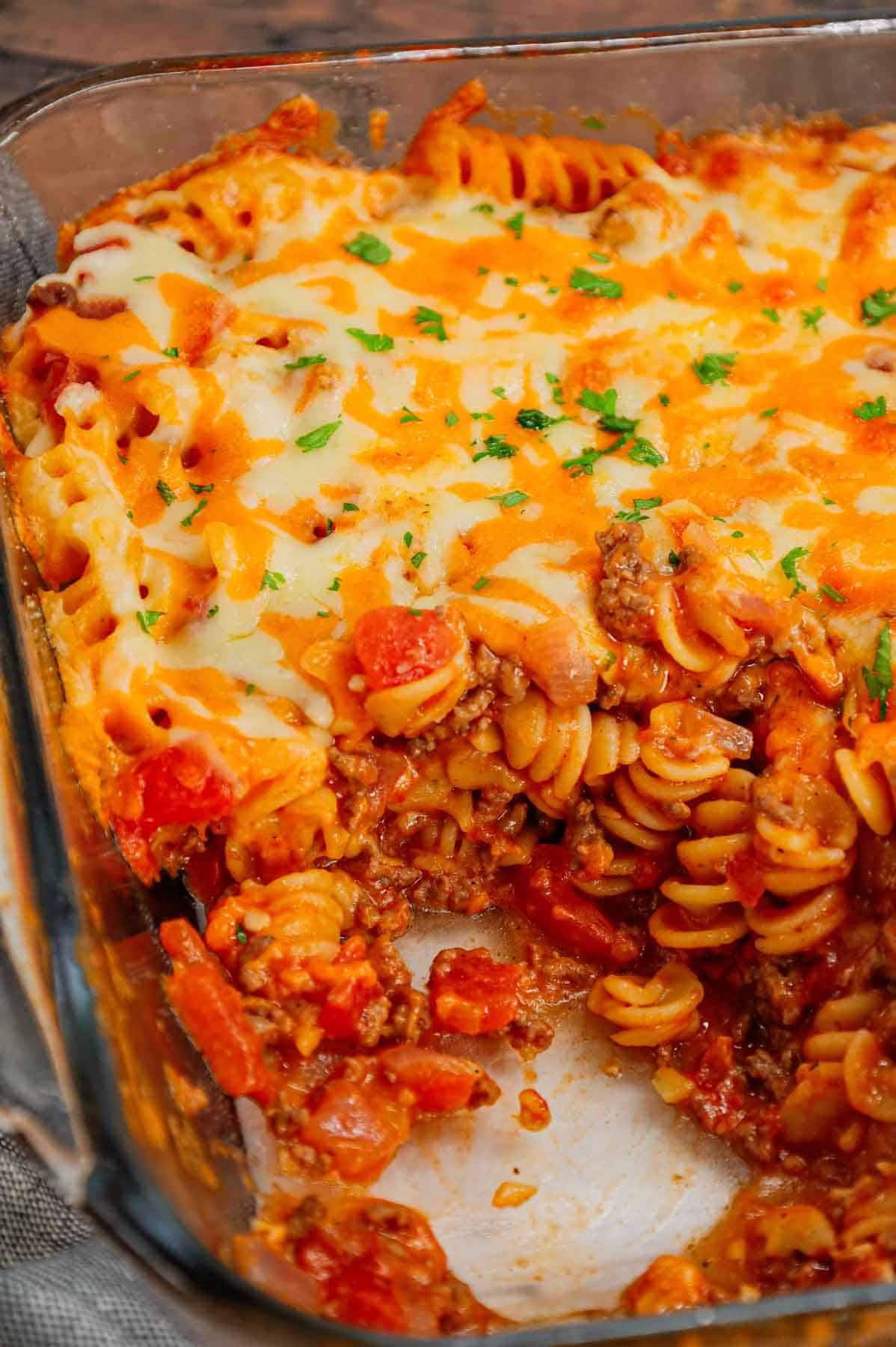 Cheeseburger Casserole is a hearty dish loaded with rotini pasta, ground beef, diced red onions, diced tomatoes, cheddar soup and shredded cheddar cheese.