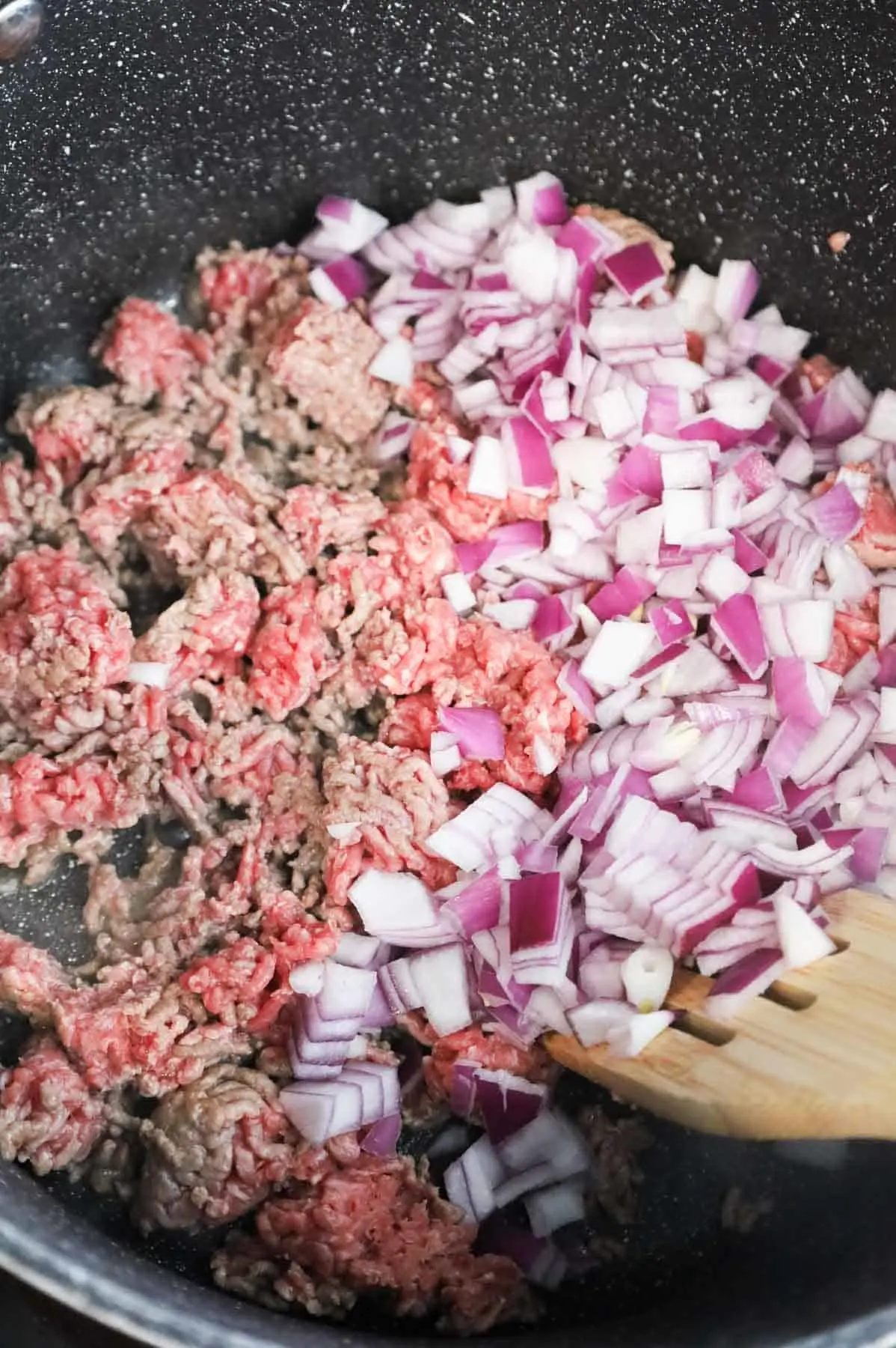 diced red onions added to pot with ground beef