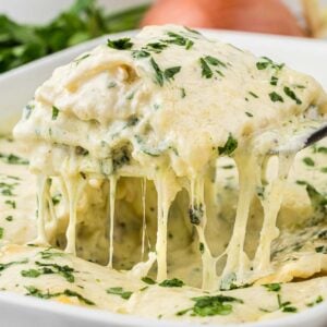 Chicken Alfredo Lasagna is a rich and delicious meal with layers of noodles, ricotta cheese, shredded chicken, mozzarella, sautéed spinach and mushrooms and a creamy Alfredo sauce.