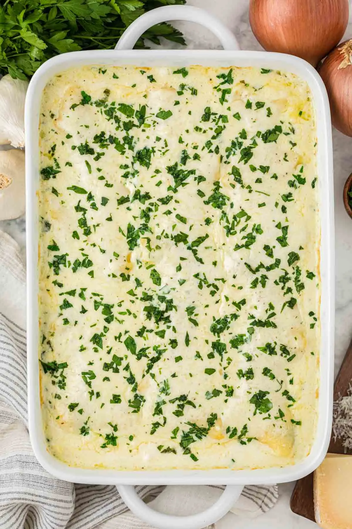 Chicken Alfredo Lasagna is a rich and delicious meal with layers of noodles, ricotta cheese, shredded chicken, mozzarella, sautéed spinach and mushrooms and a creamy Alfredo sauce.