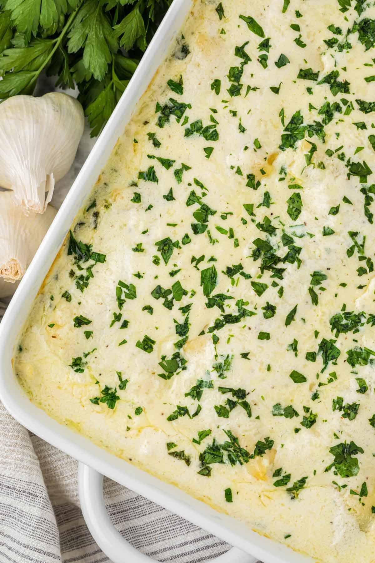 Chicken Alfredo Lasagna is a rich and delicious meal with layers of noodles, ricotta cheese, shredded chicken, mozzarella, sautéed spinach and mushrooms and a creamy Alfredo sauce.