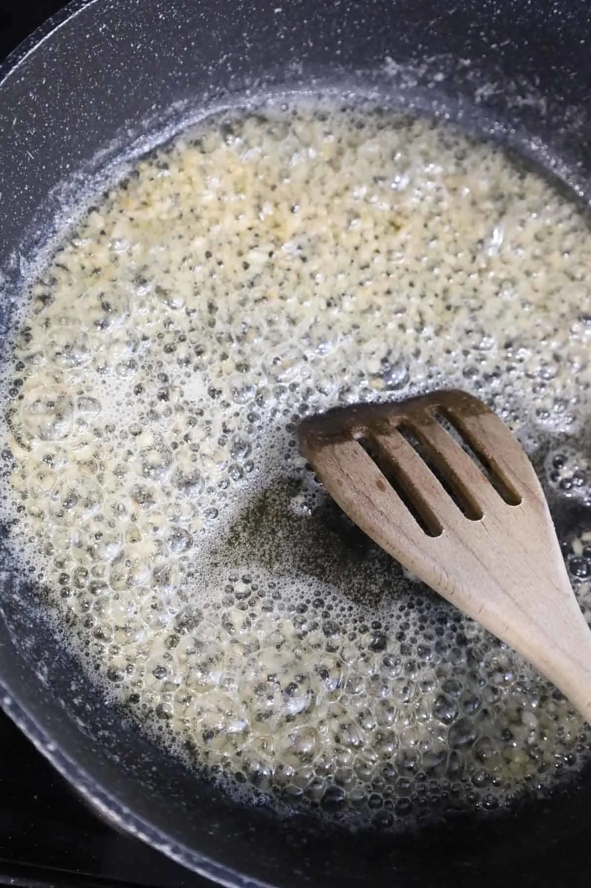 stirring melted butter and minced garlic in a skillet
