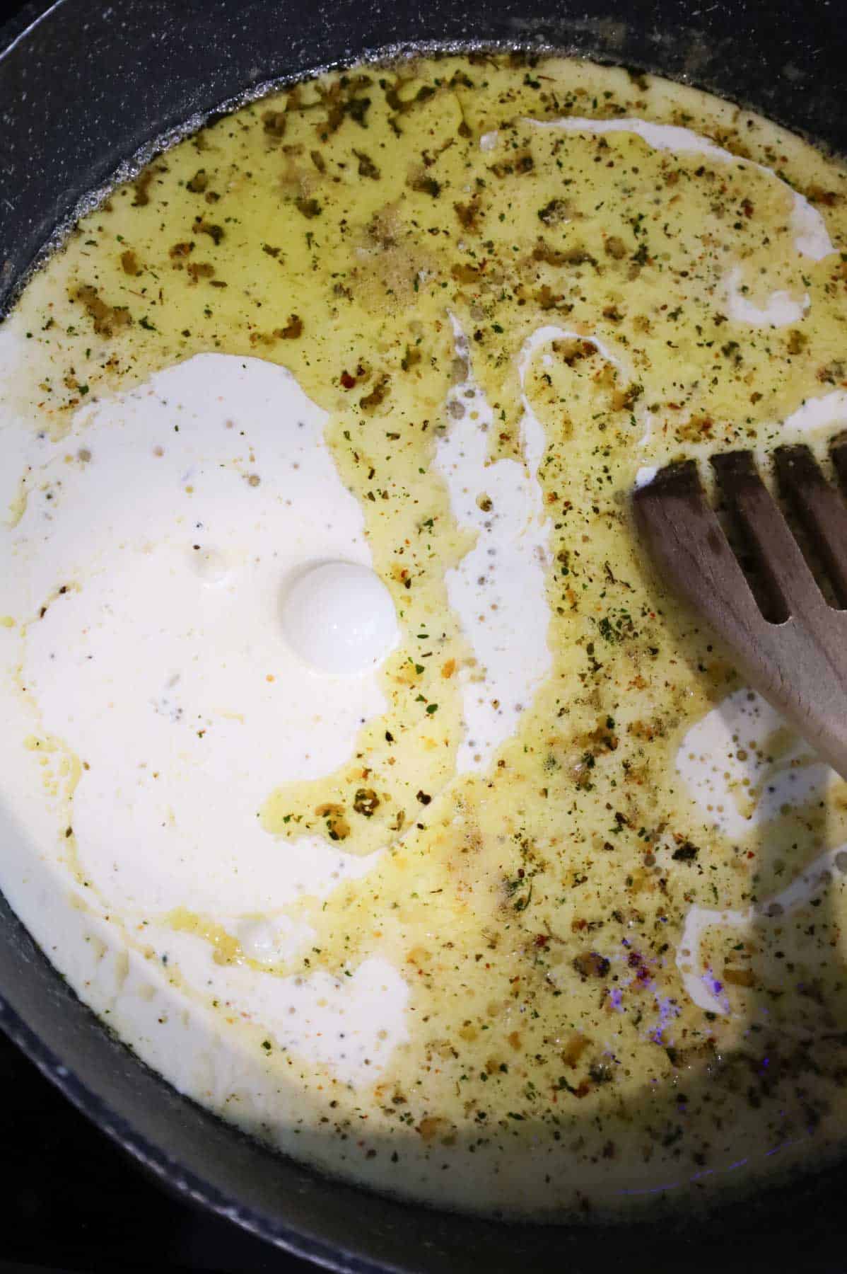 heavy cream added to skillet with butter and garlic