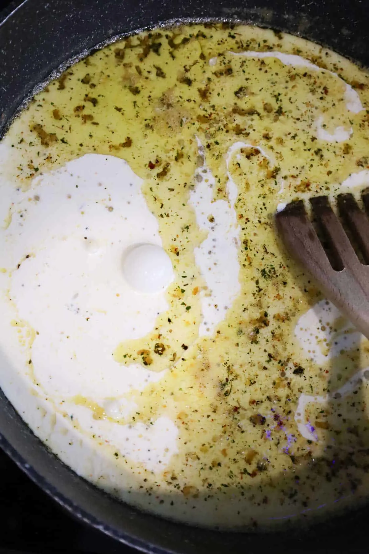 heavy cream added to skillet with butter and garlic