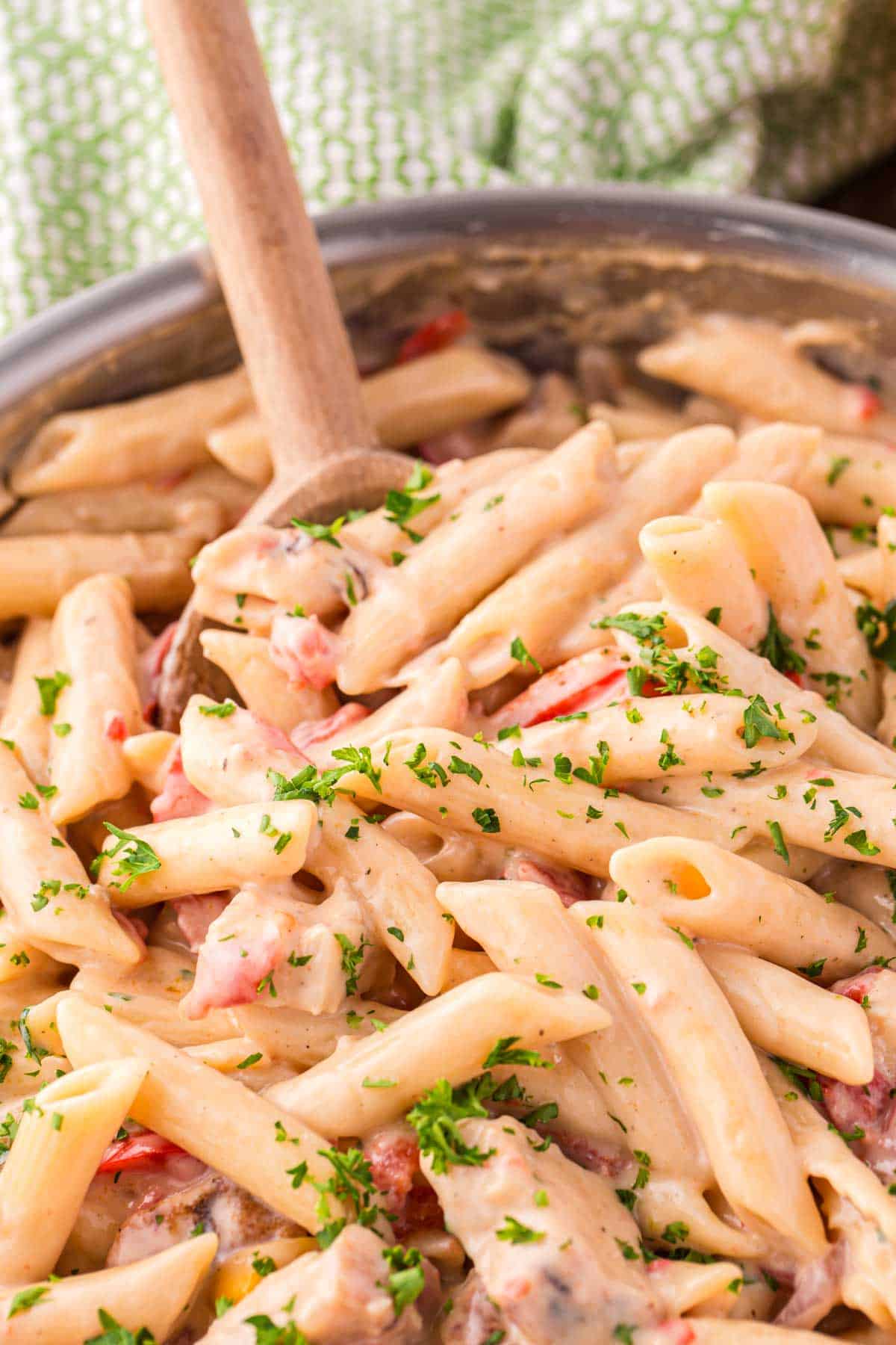 Creamy Chicken Fajita Pasta is a hearty pasta recipe loaded with chicken breast strips, sliced bell peppers, fajita seasoning, fire-roasted Rotel, penne noodles and pepper jack cheese.