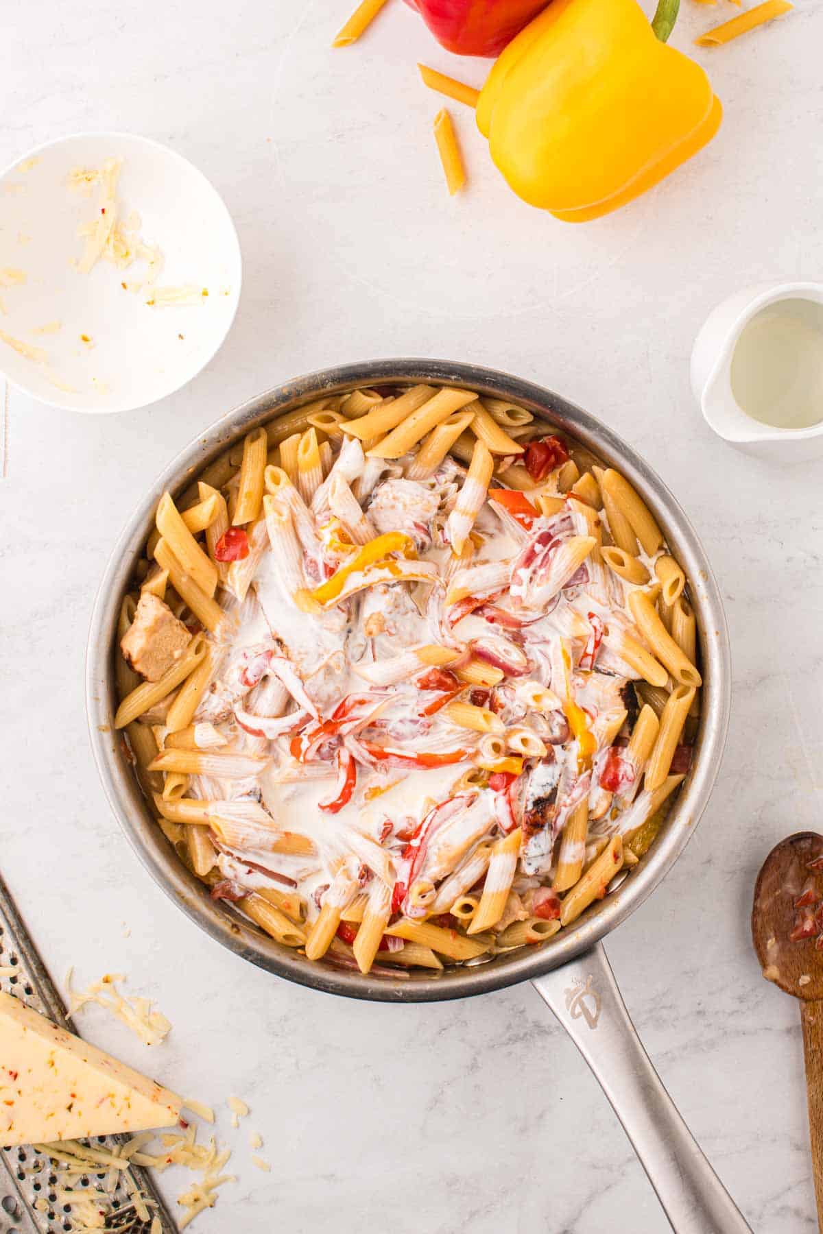 heavy cream added to skillet with chicken penne pasta