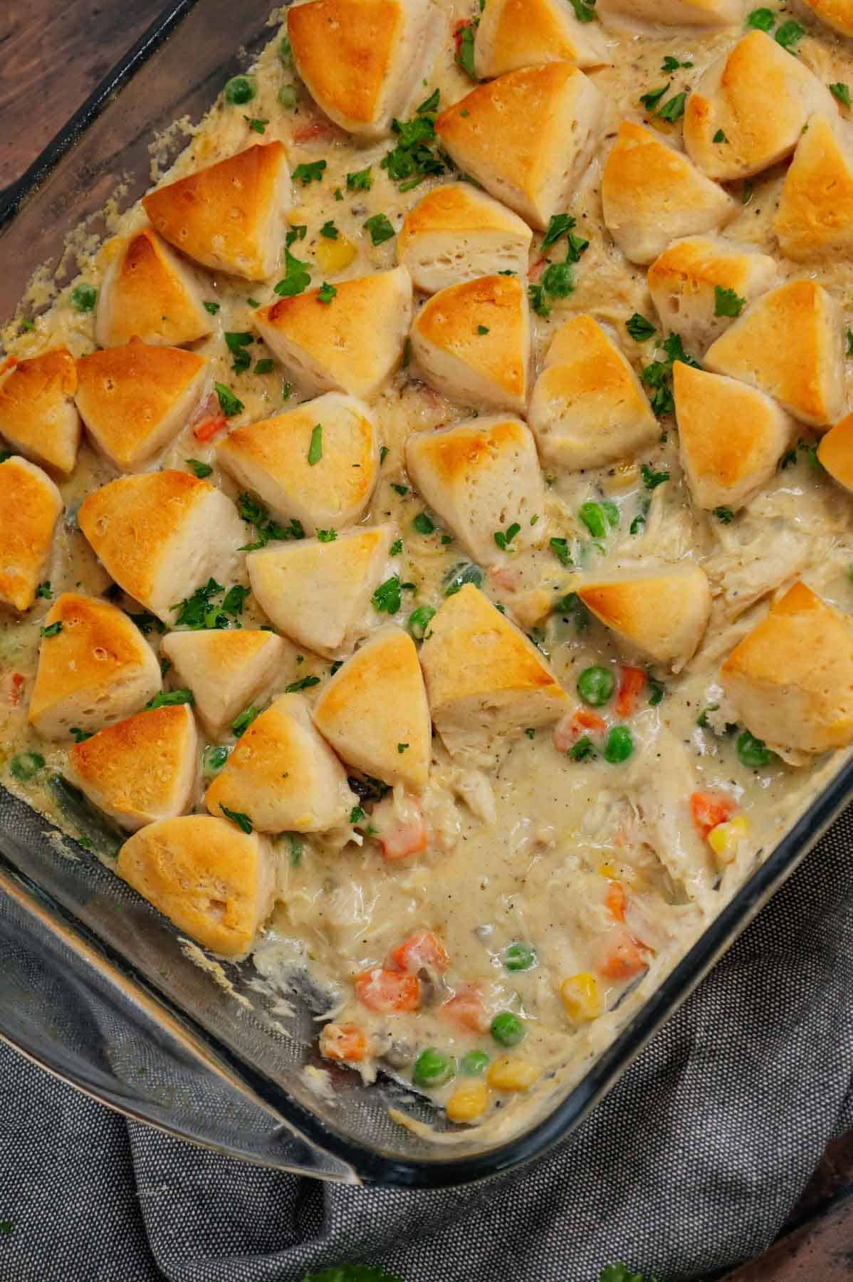 Chicken Pot Pie Casserole is a hearty casserole loaded with shredded rotisserie chicken, frozen mixed vegetables, cream of mushroom soup, cream of chicken soup, milk, grated parmesan cheese and chopped Pillsbury biscuits.