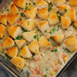 Chicken Pot Pie Casserole is a hearty casserole loaded with shredded rotisserie chicken, frozen mixed vegetables, cream of mushroom soup, cream of chicken soup, milk, grated parmesan cheese and chopped Pillsbury biscuits.