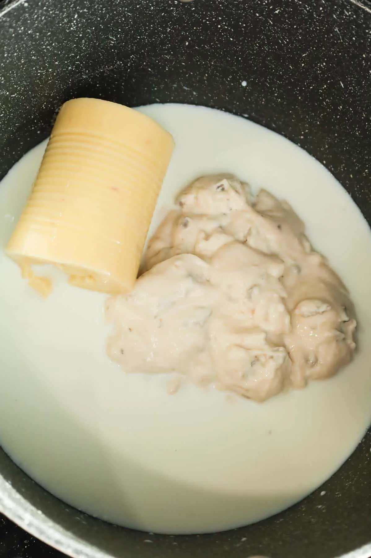 cream of mushroom soup, cream of chicken soup and milk in a large pot