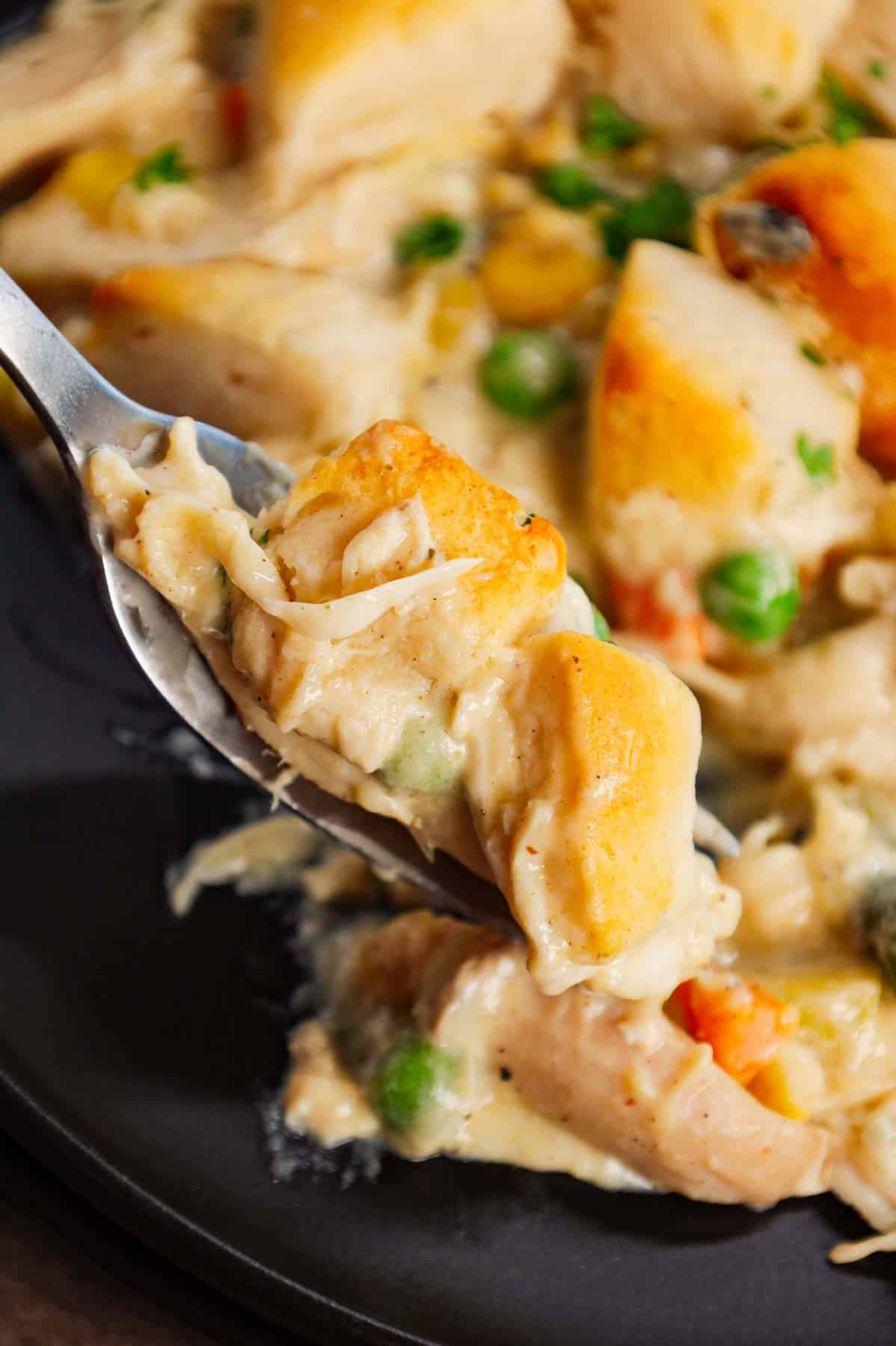 Chicken Pot Pie Casserole is a hearty casserole loaded with shredded rotisserie chicken, frozen mixed vegetables, cream of mushroom soup, cream of chicken soup, milk, grated parmesan cheese and chopped Pillsbury biscuits.