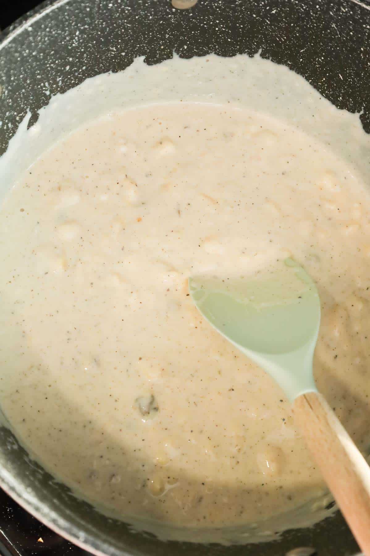 cream of chicken, cream of mushroom, milk and spices mixture in a large pot