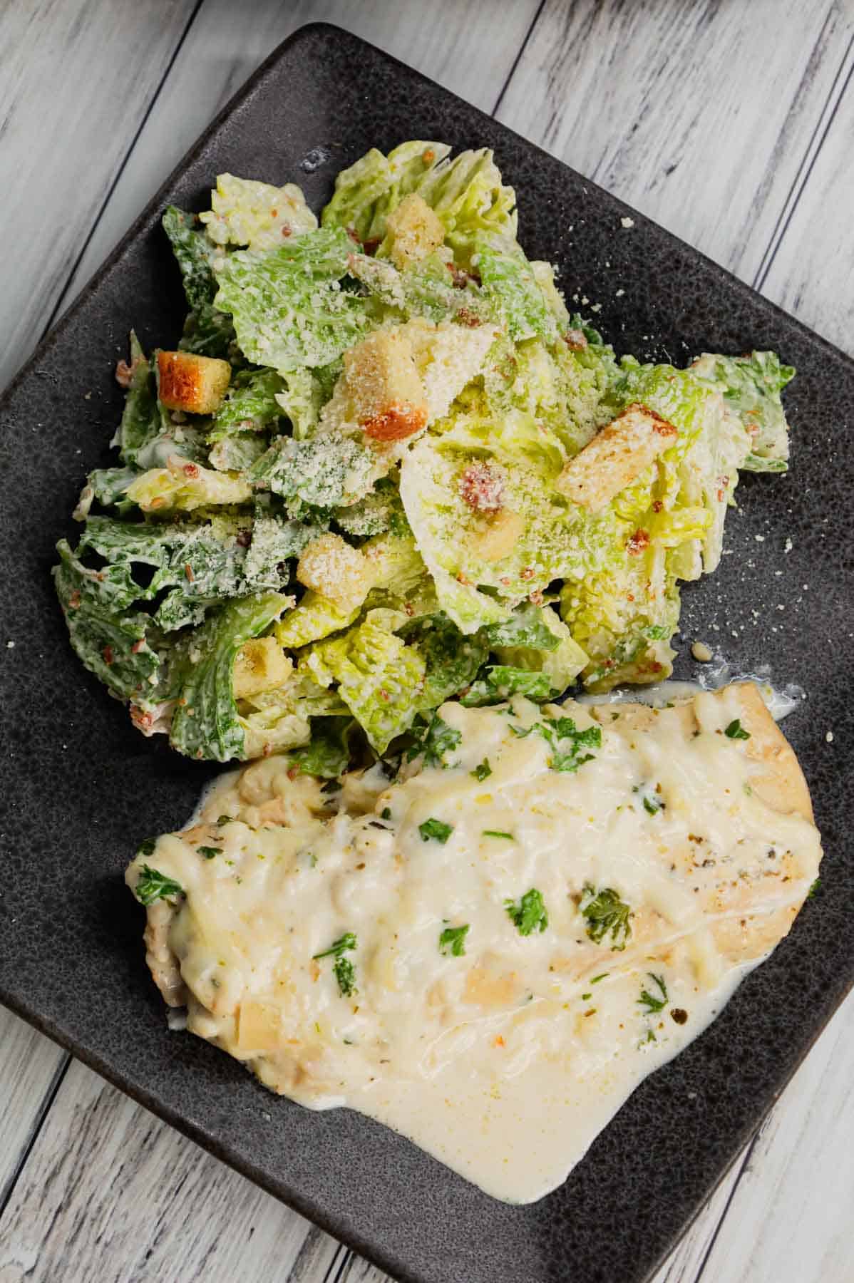 Crock Pot Parmesan Garlic Chicken is a rich and delicious slow cooker dish made with boneless, skinless chicken breasts in a creamy sauce loaded with minced garlic, parmesan cheese, Italian seasoning, fresh chopped parsley, cream cheese and mozzarella cheese.