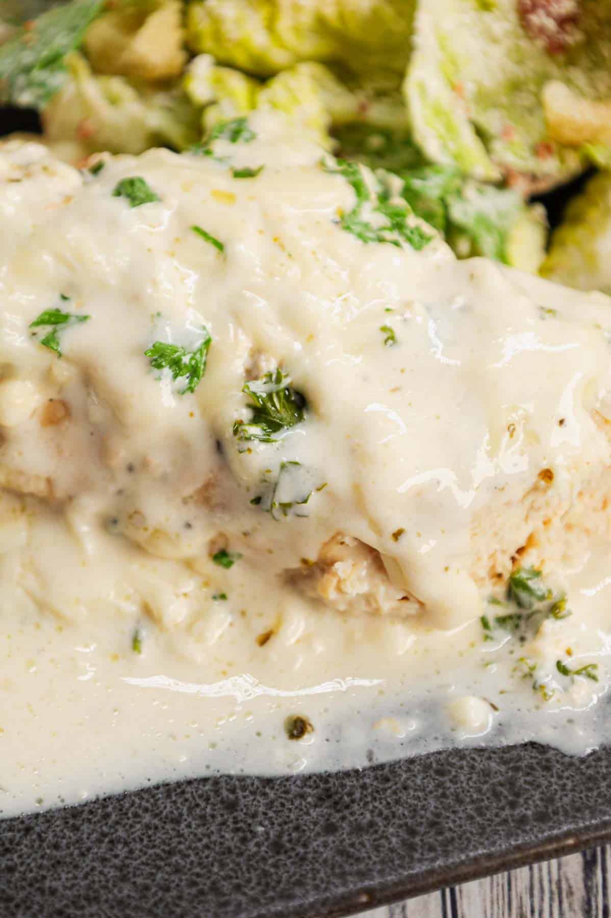 Crock Pot Parmesan Garlic Chicken is a rich and delicious slow cooker dish made with boneless, skinless chicken breasts in a creamy sauce loaded with minced garlic, parmesan cheese, Italian seasoning, fresh chopped parsley, cream cheese and mozzarella cheese.