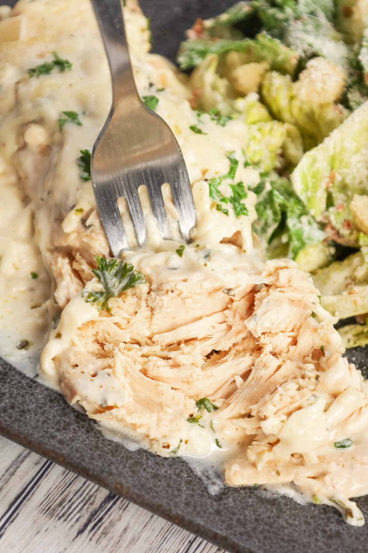 Crock Pot Parmesan Garlic Chicken is a rich and delicious slow cooker dish made with boneless, skinless chicken breasts in a creamy sauce loaded with minced garlic, parmesan cheese, Italian seasoning, fresh chopped parsley, cream cheese and mozzarella cheese.