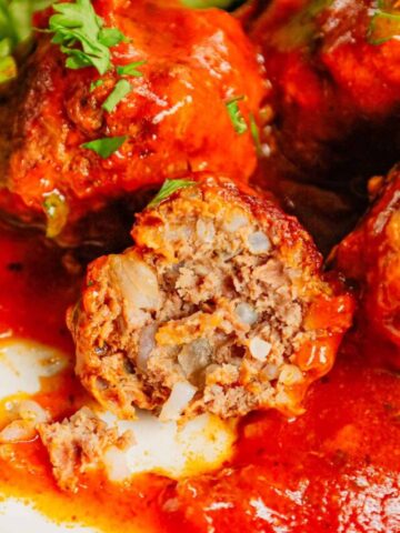 Porcupine Meatballs are delicious meatballs made with ground beef, Minute rice and diced onions all in a flavourful sauce made with condensed tomato soup, Worcestershire sauce and Italian seasoning.