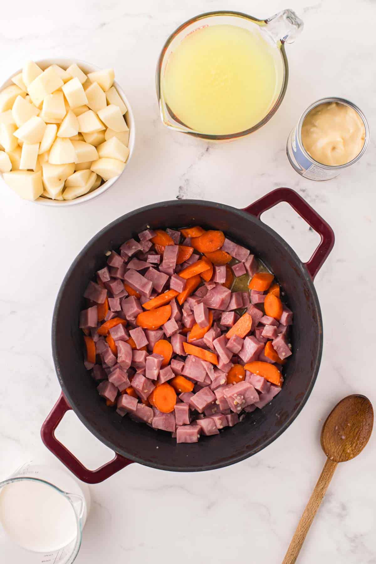 diced ham and carrots cooking in a pot