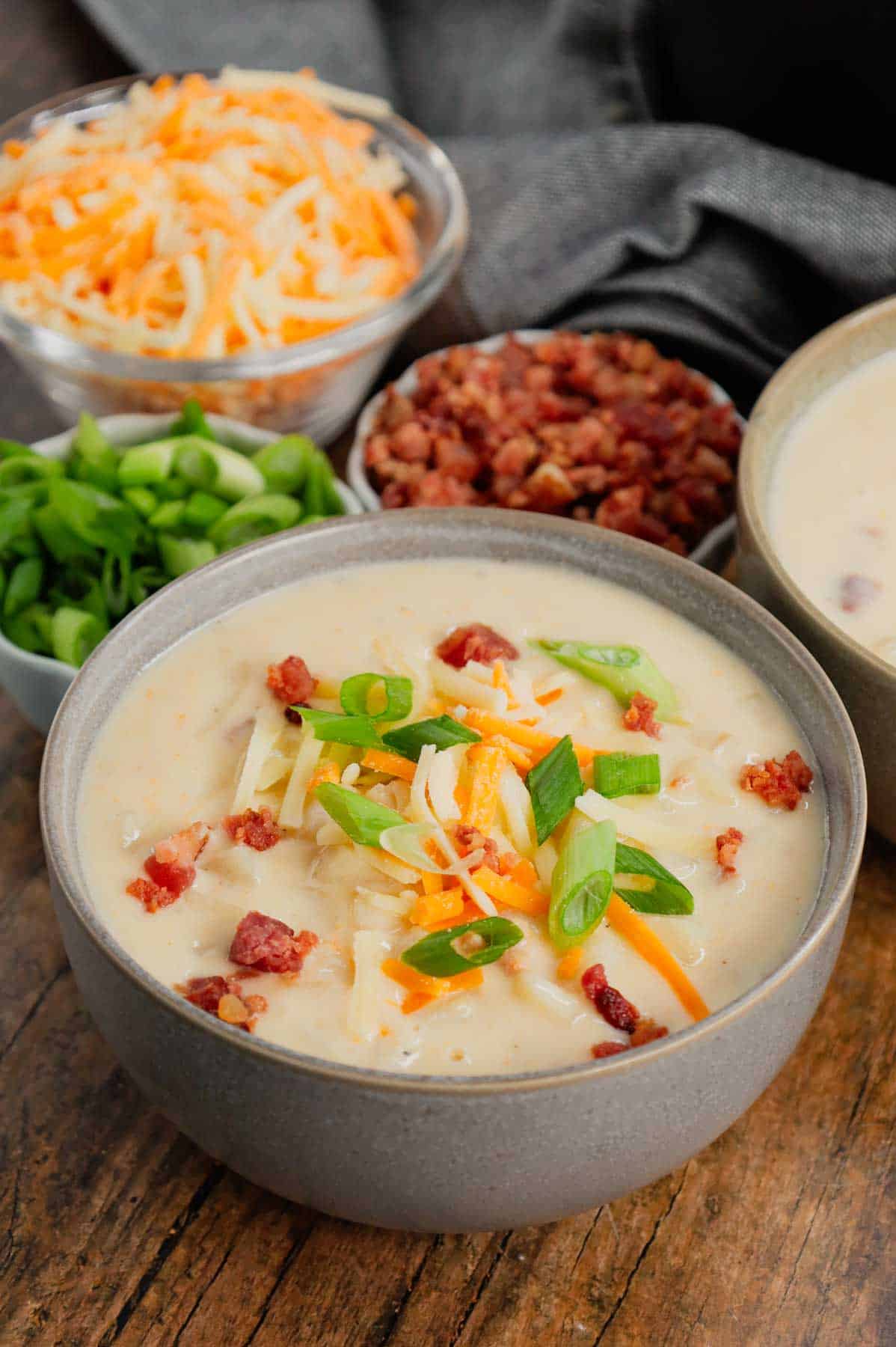 Hash Brown Potato Soup is a hearty soup recipe made with frozen diced hash brown potatoes, chicken broth, milk, diced onions, bacon crumble and cheddar cheese.