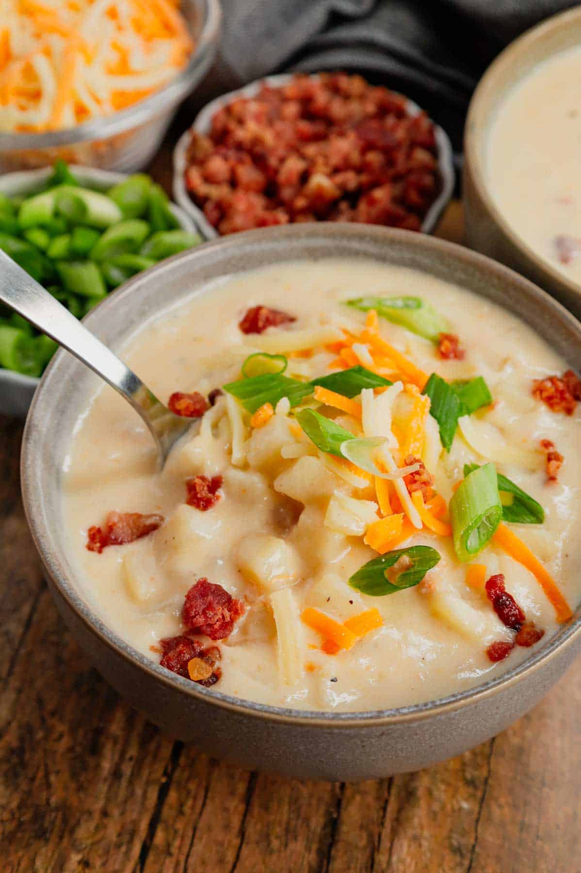 Hash Brown Potato Soup is a hearty soup recipe made with frozen diced hash brown potatoes, chicken broth, milk, diced onions, bacon crumble and cheddar cheese.