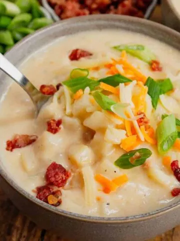 Hash Brown Potato Soup is a hearty soup recipe made with frozen diced hash brown potatoes, chicken broth, milk, diced onions, bacon crumble and cheddar cheese.