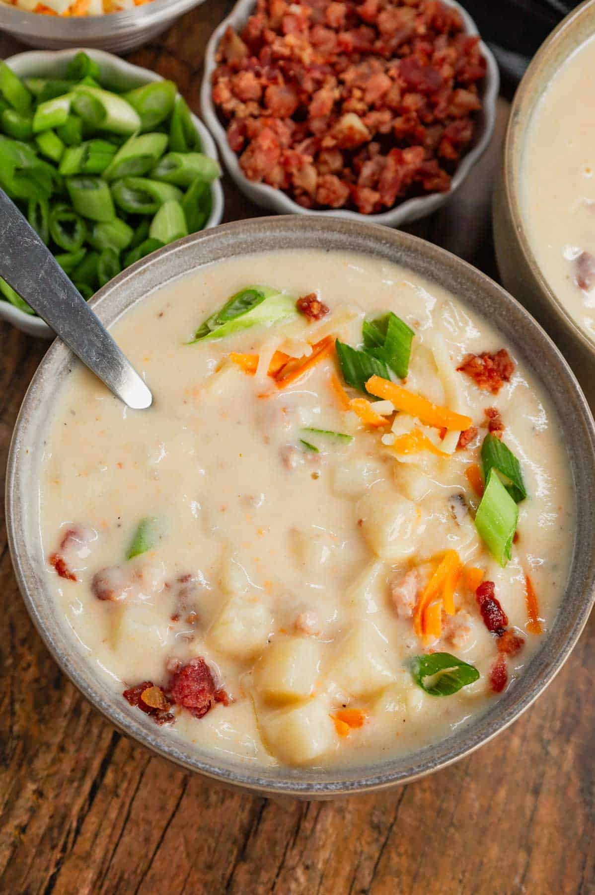 Hash Brown Potato Soup is a hearty soup recipe made with frozen diced hash brown potatoes, chicken broth, milk, diced onions, bacon crumble and cheddar cheese.