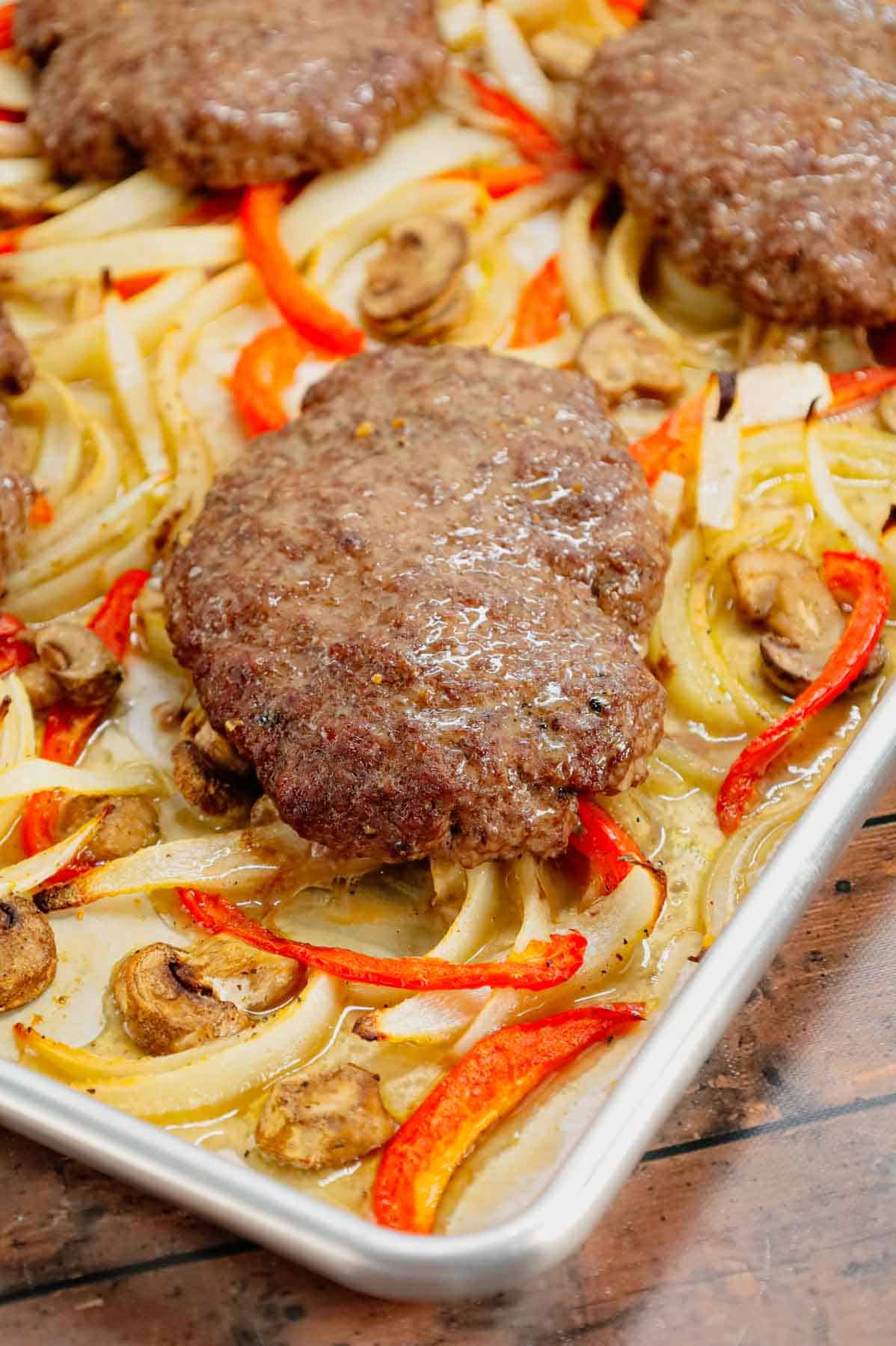 Oven Baked Hamburger Steaks are an easy sheet pan dinner recipe with seasoned ground beef patties cooked along with sliced onions, red bell peppers and mushrooms.