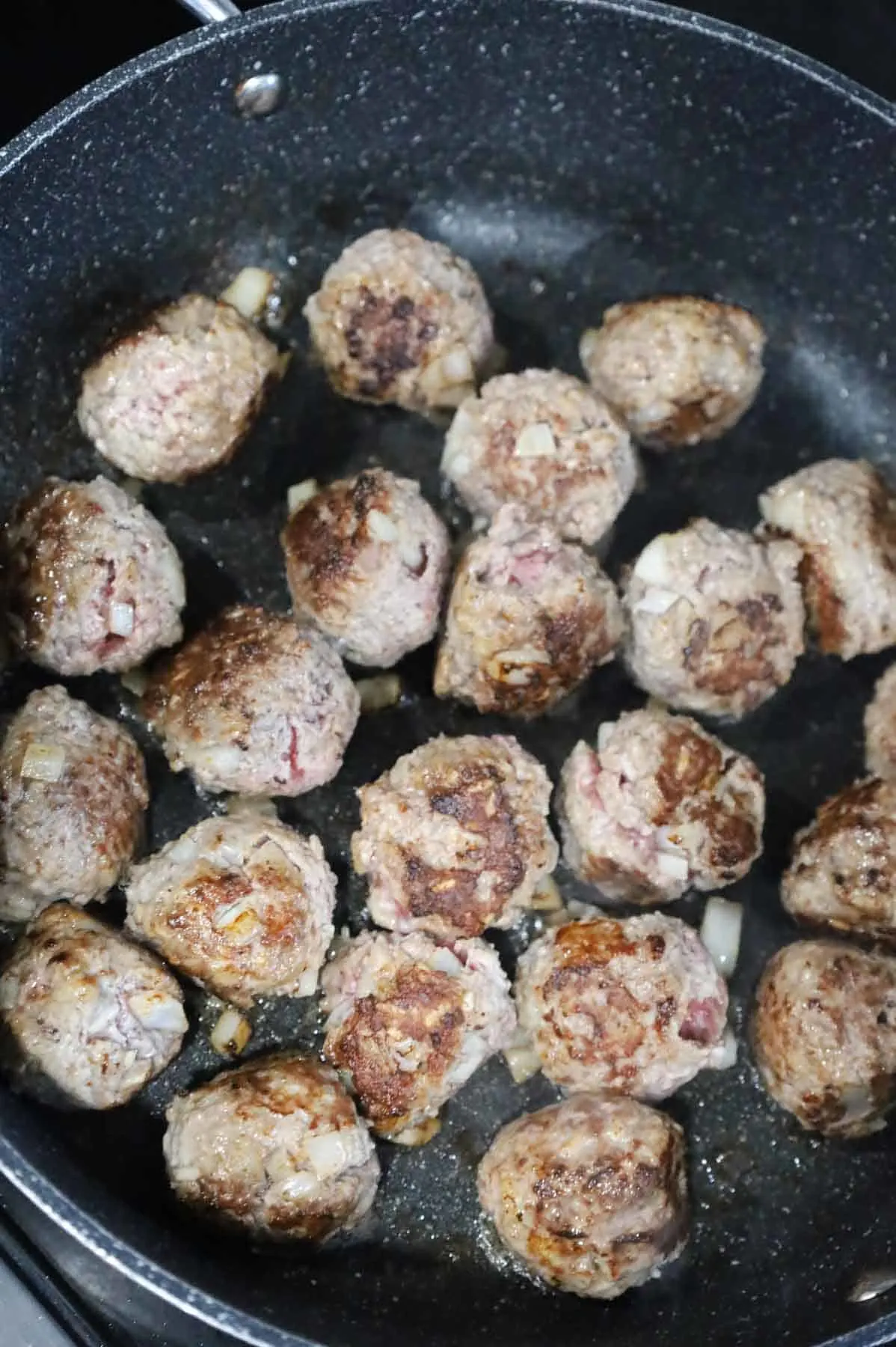 browned meatballs in a skillet