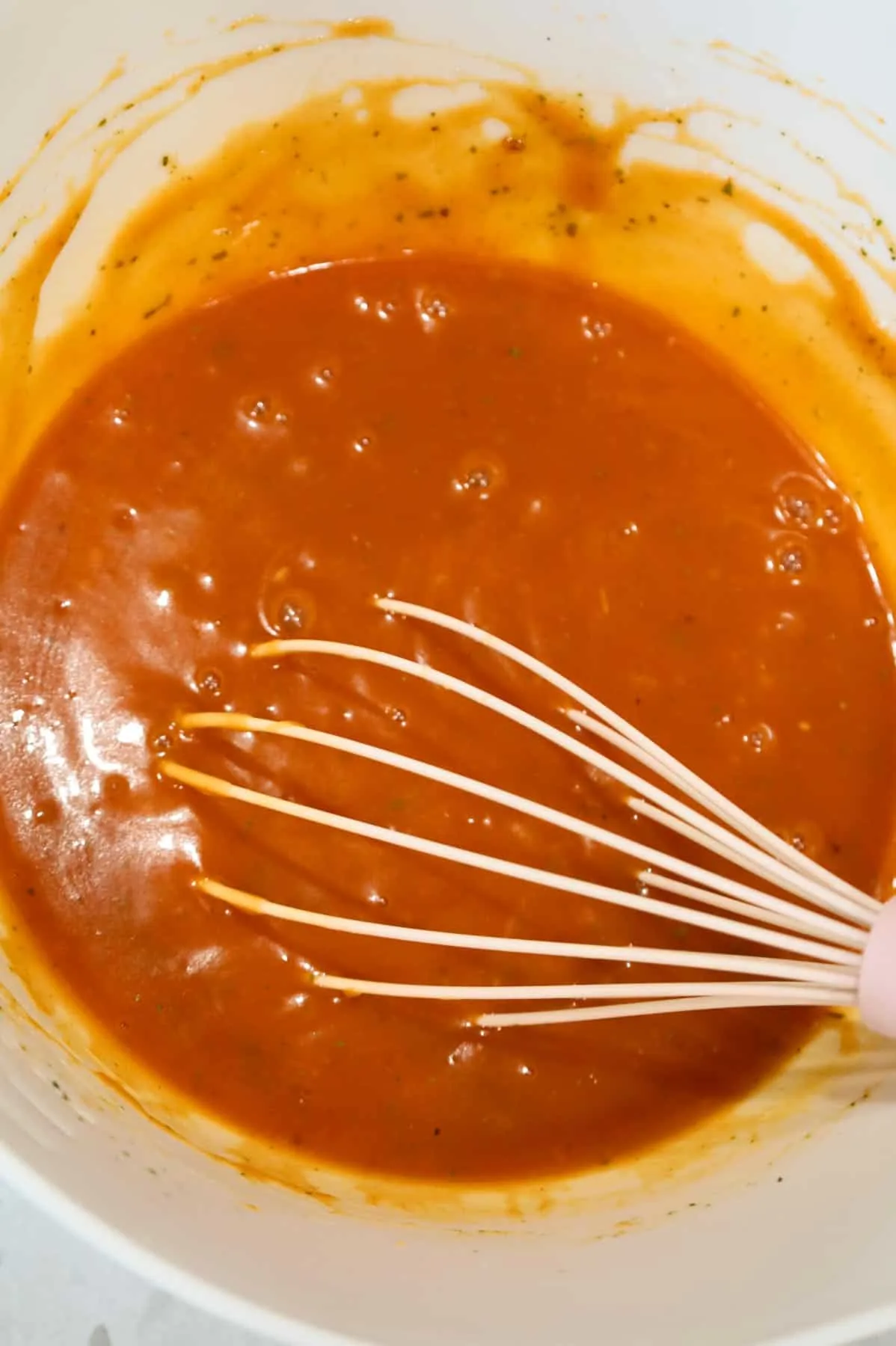 tomato soup mixture being whisked in a bowl