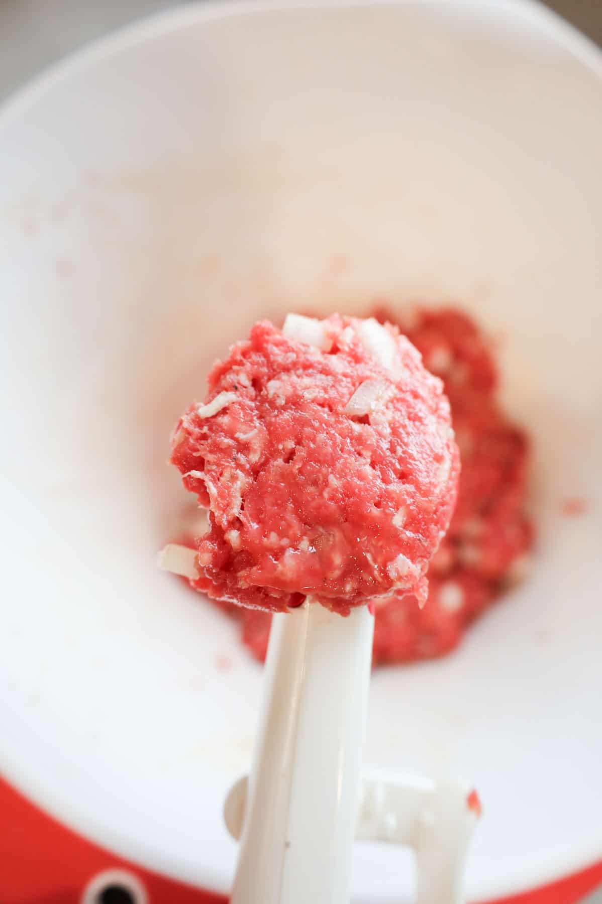 raw meat mixture in a cookie scoop