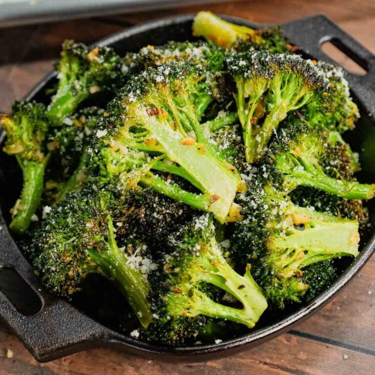 Roasted Broccoli is a simple and delicious side dish made with broccoli florets tossed in olive oil, minced garlic, salt, pepper, Italian seasoning and parmesan cheese and roasted until tender and slightly crispy.