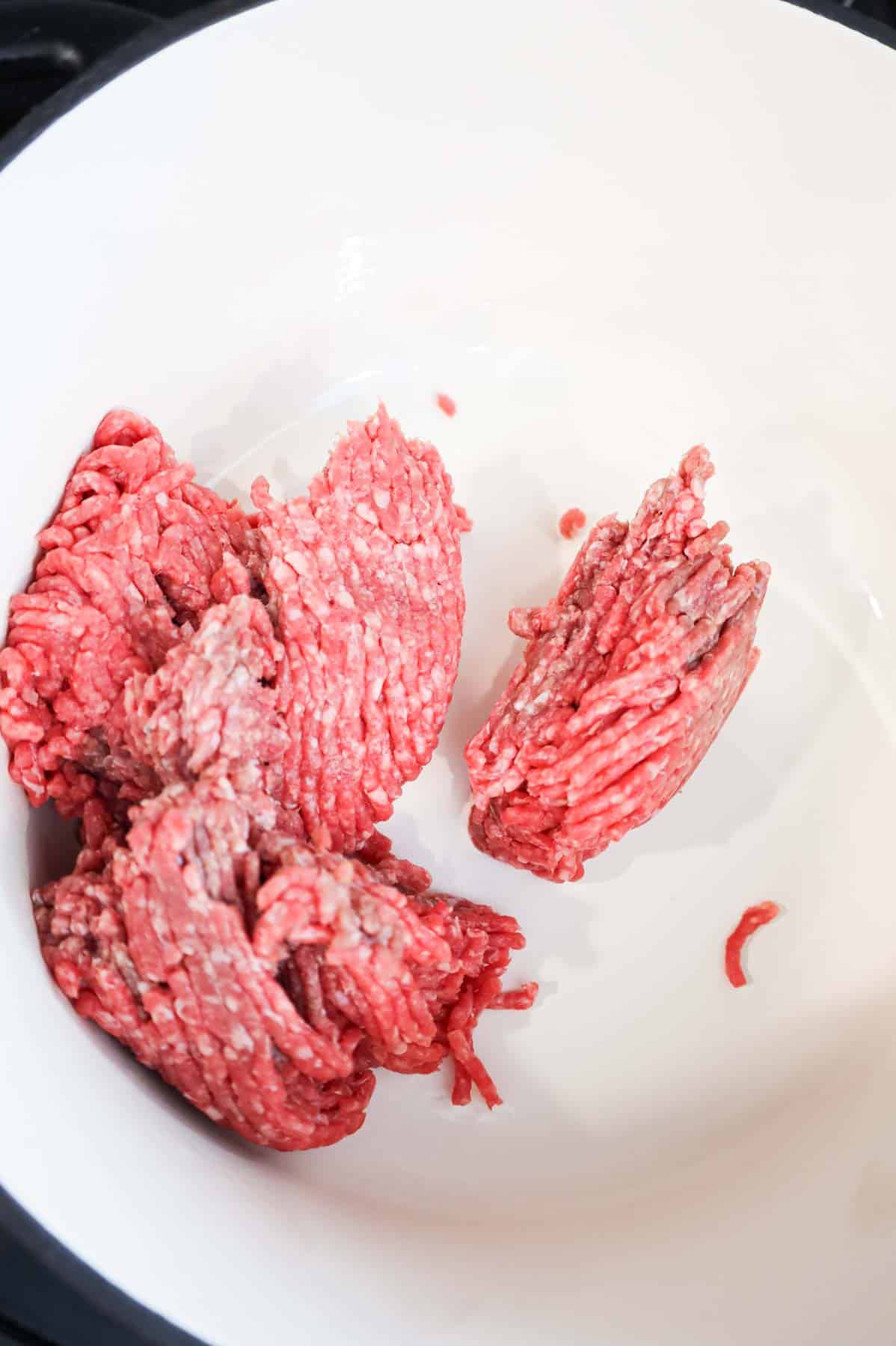 raw ground beef in a Dutch oven