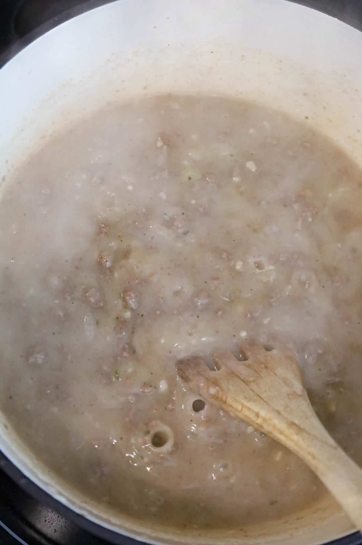 stirring instant mashed potatoes into broth and ground beef mixture
