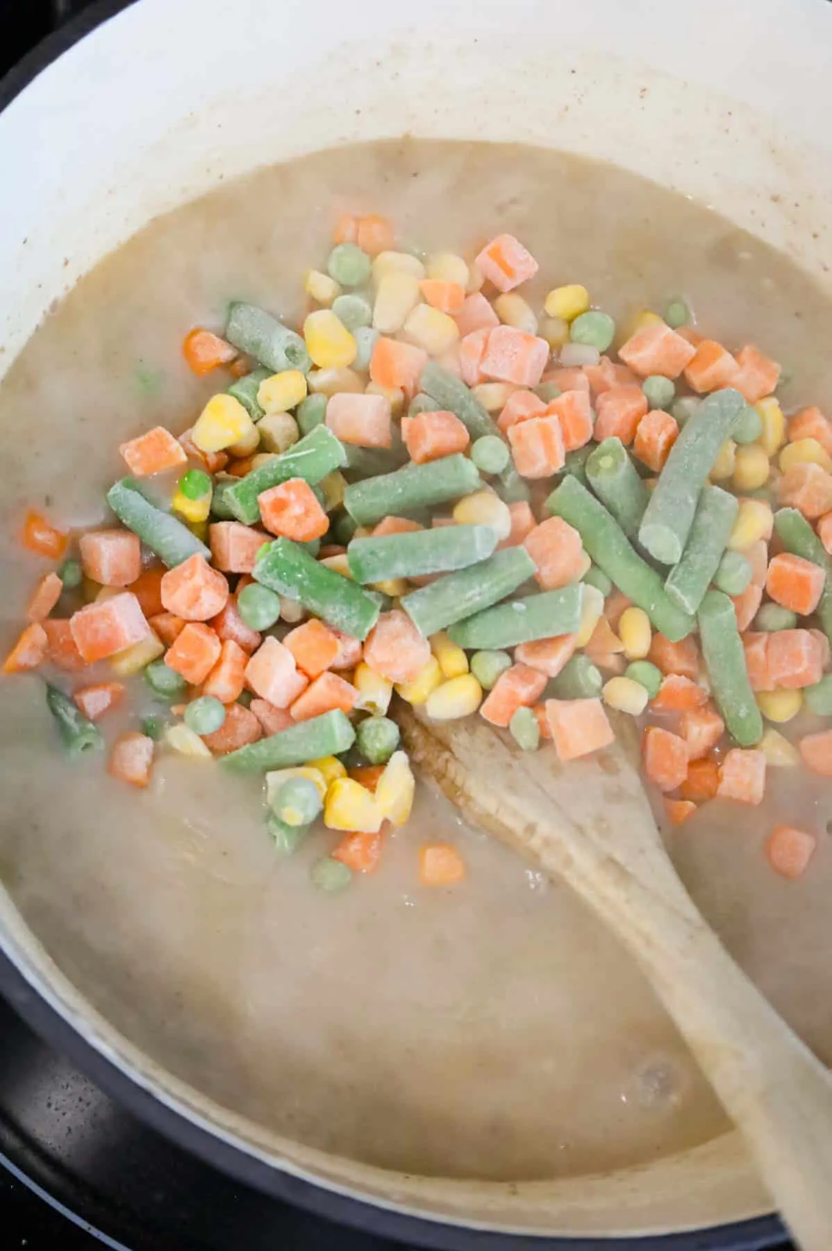frozen mixed vegetables added to pot with shepherd's pie soup