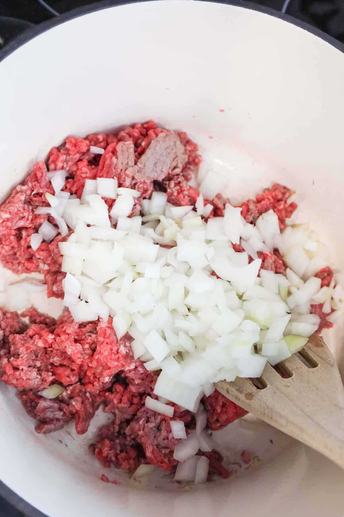 diced onions and ground beef in a Dutch oven