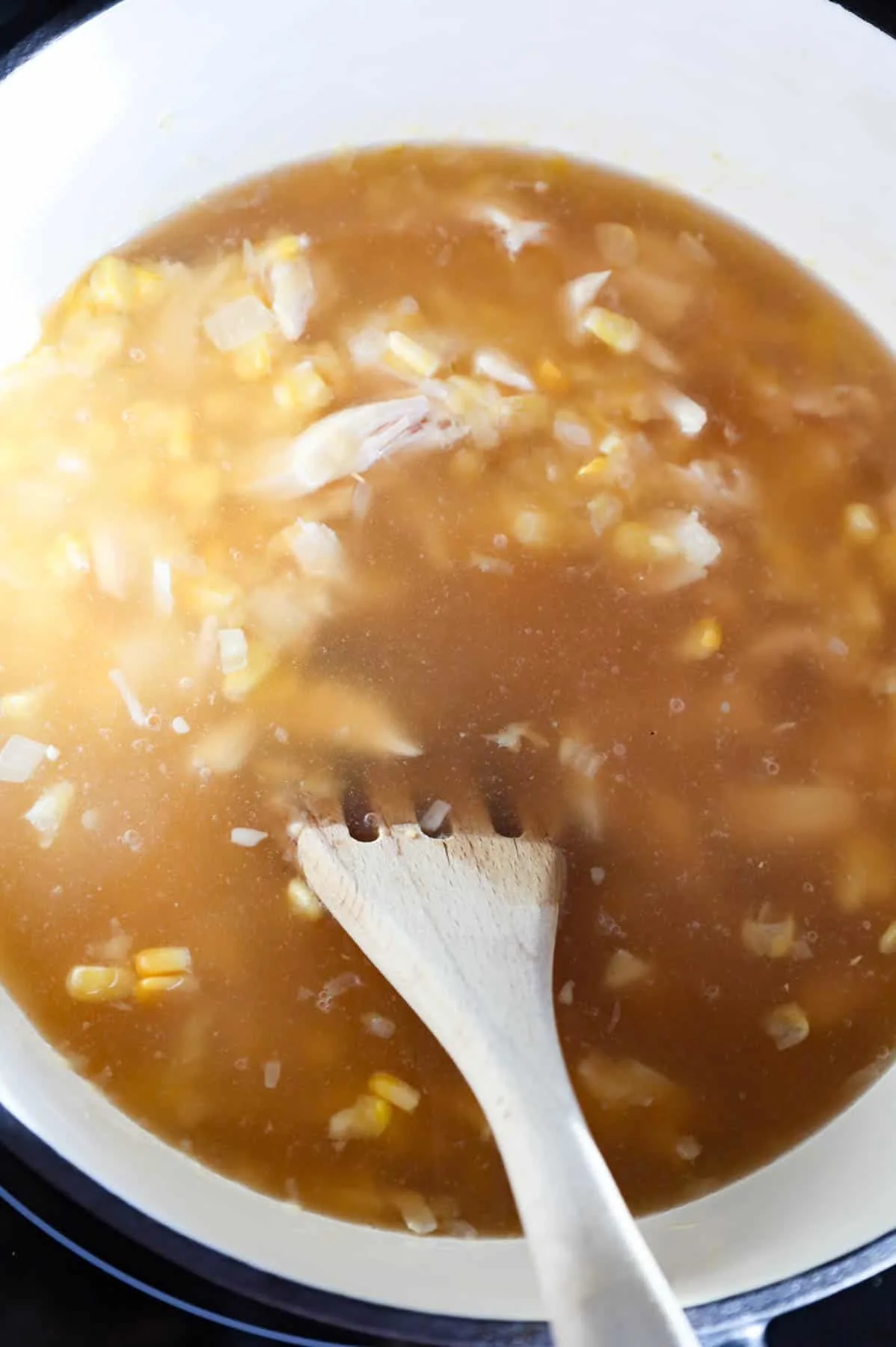 chicken broth added to pot with corn, onions and shredded chicken