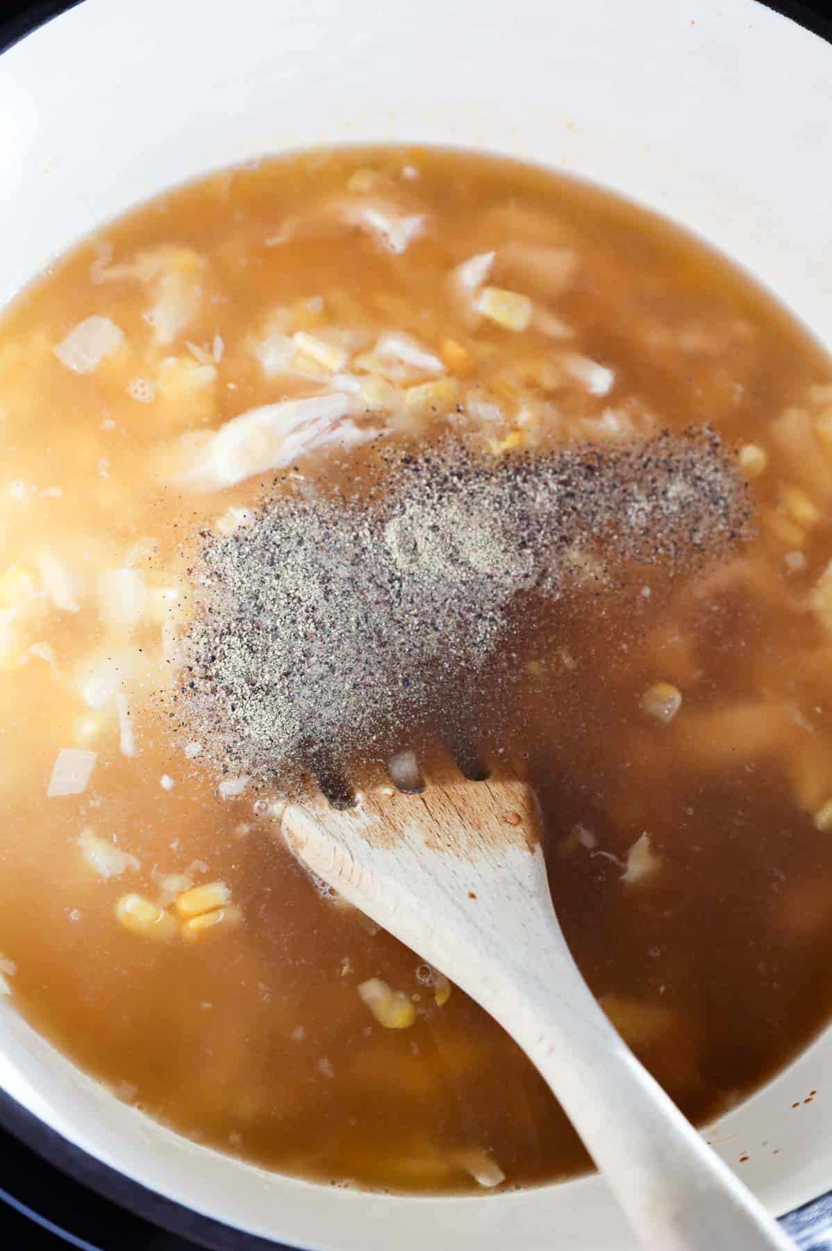 soy sauce and pepper added to sweet corn soup