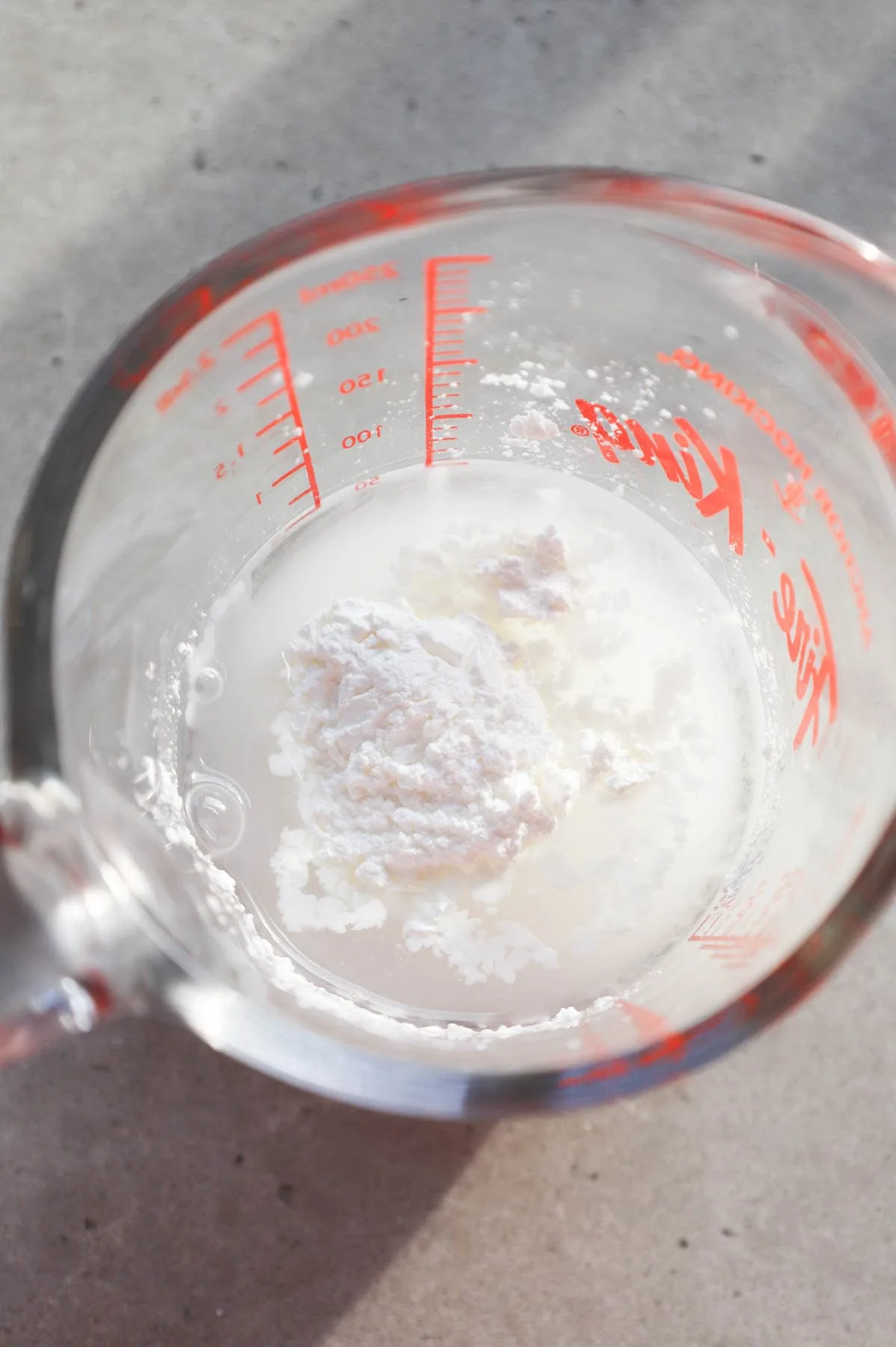 water and cornstarch in a glass measuring cup