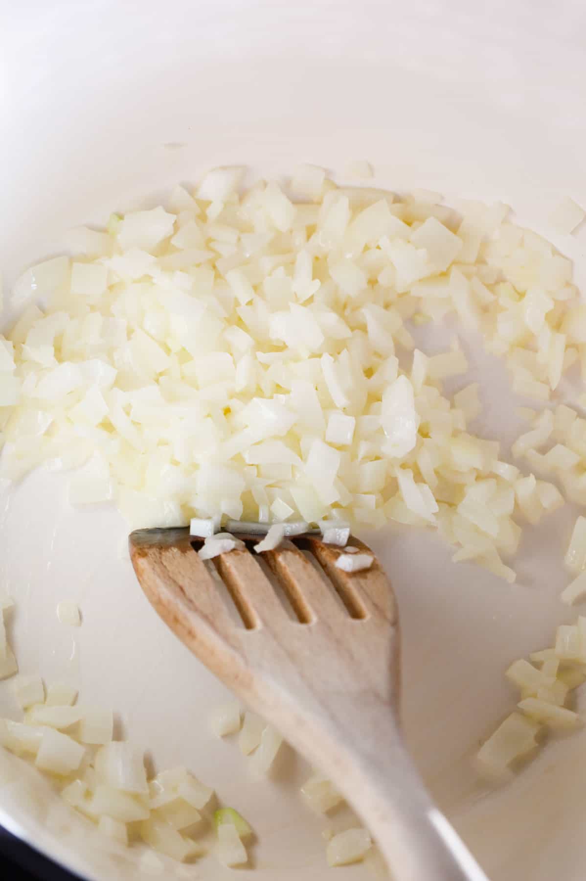 diced onions cooking in butter in a pot