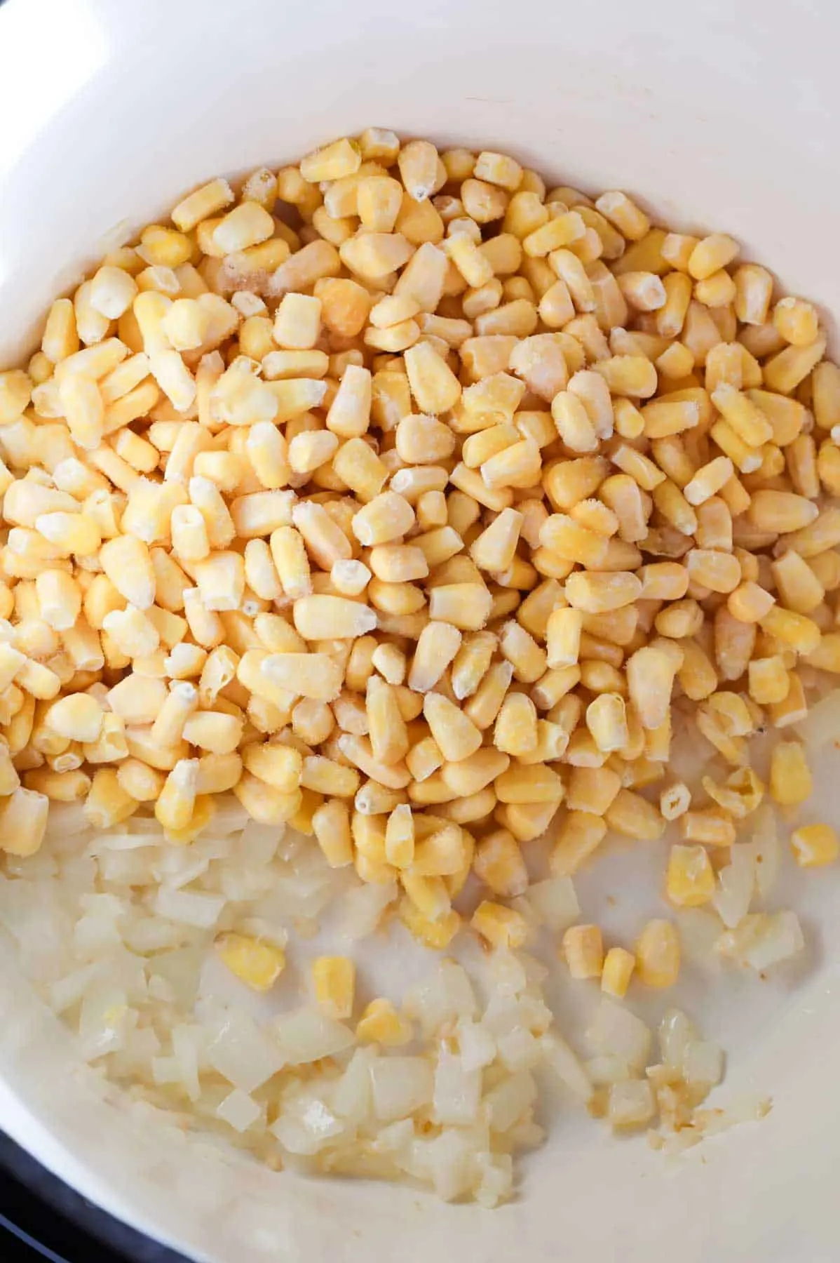 frozen corn added to pot with diced onions