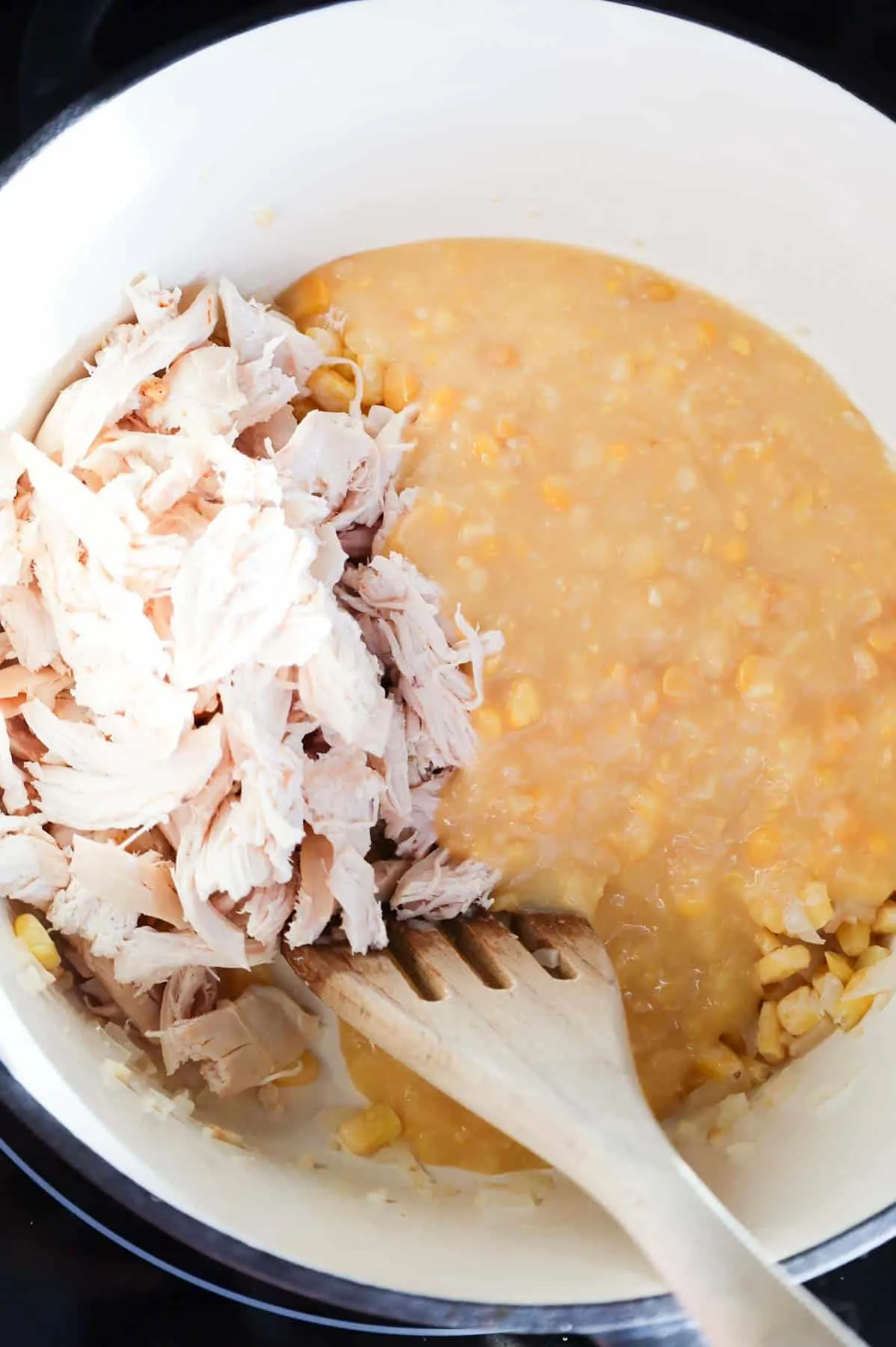 shredded chicken and creamed corn in a pot